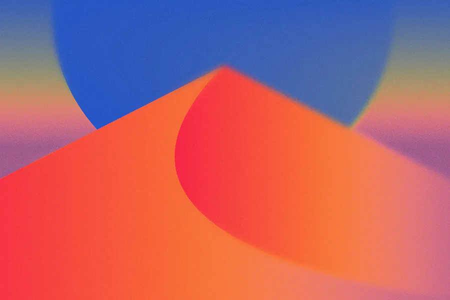 A soft-focus, grainy gradient wallpaper featuring a stylized desert dune in vibrant orange and red. A large, blurry blue circular shape—reminiscent of a sun or moon—rises behind the dune against a colorful twilight sky.