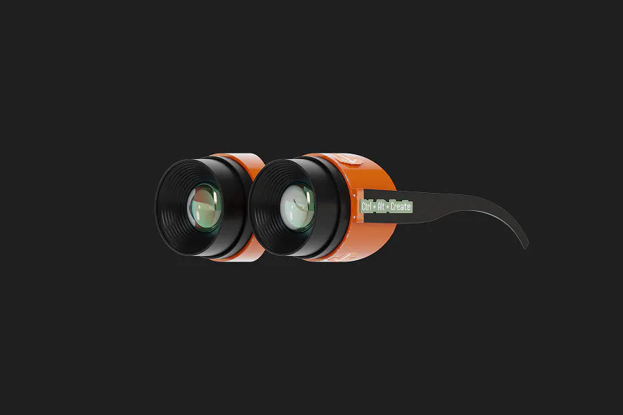 A high-contrast wallpaper on a dark grey background featuring a pair of futuristic orange goggles or binoculars. The side arm of the goggles has a small green label that reads "Ctrl + Alt + Create."
