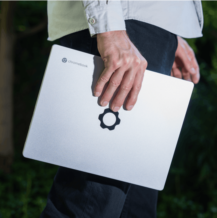 A person carrying a Framework Laptop Chromebook Edition