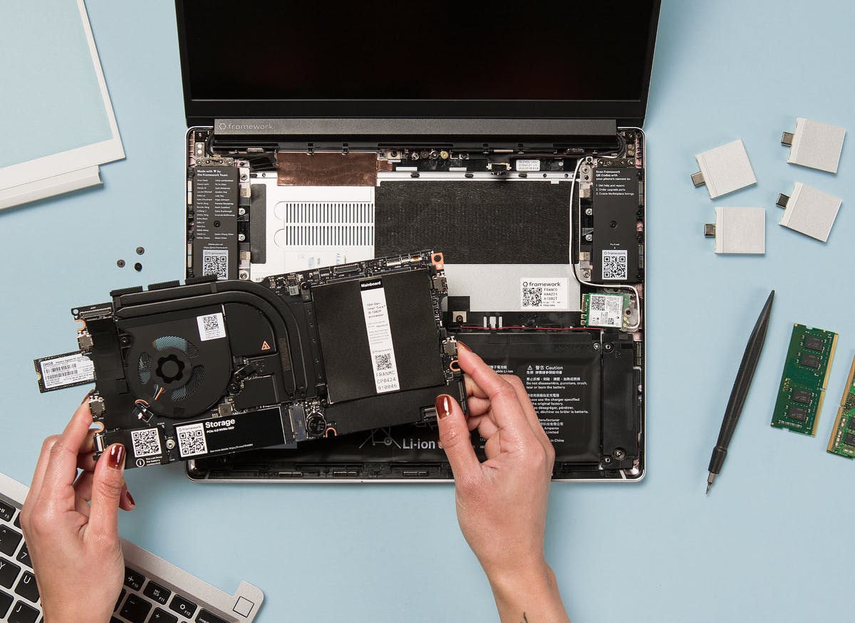 Holding a Framework Laptop Mainboard