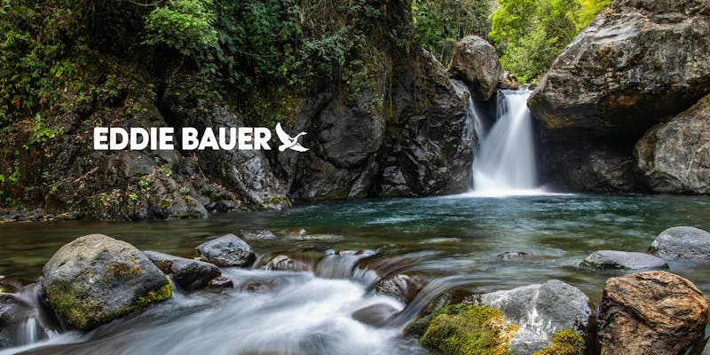 Eddie Bauer white logo with river and waterfall