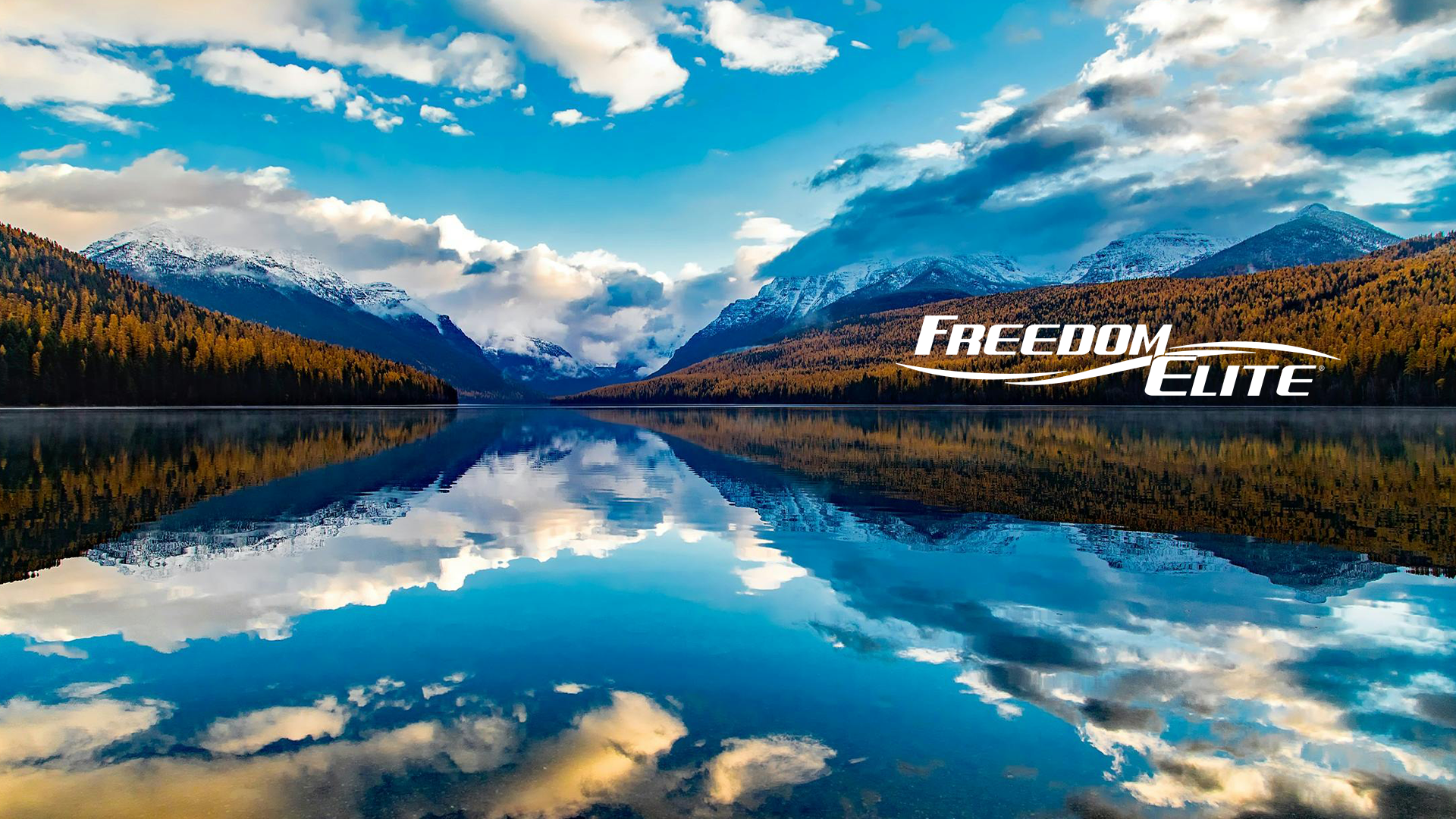 Freedom Elite logo with beautiful mountains and lake view