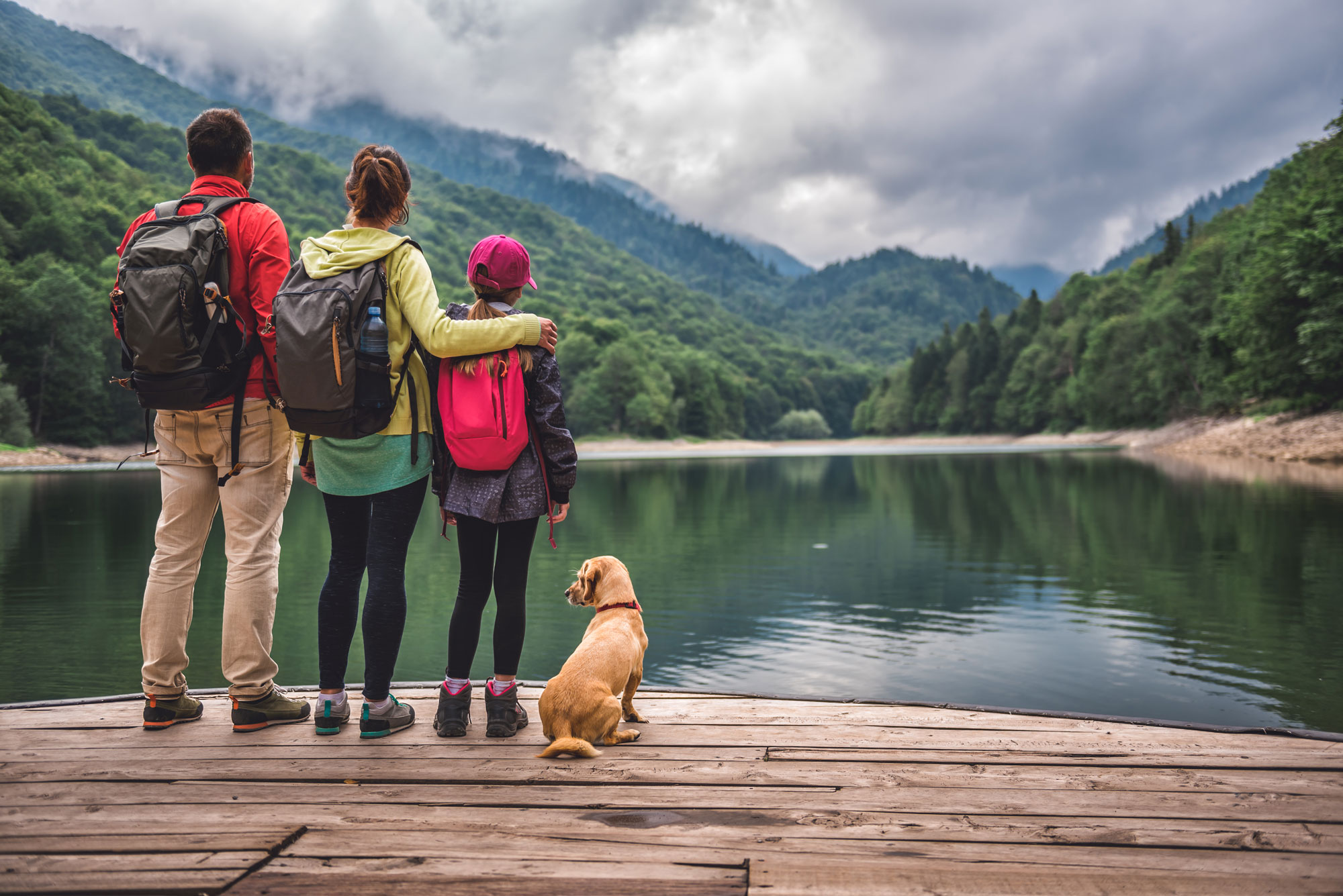 Stock photo FAQs link photo family overlooking mountains and water out West