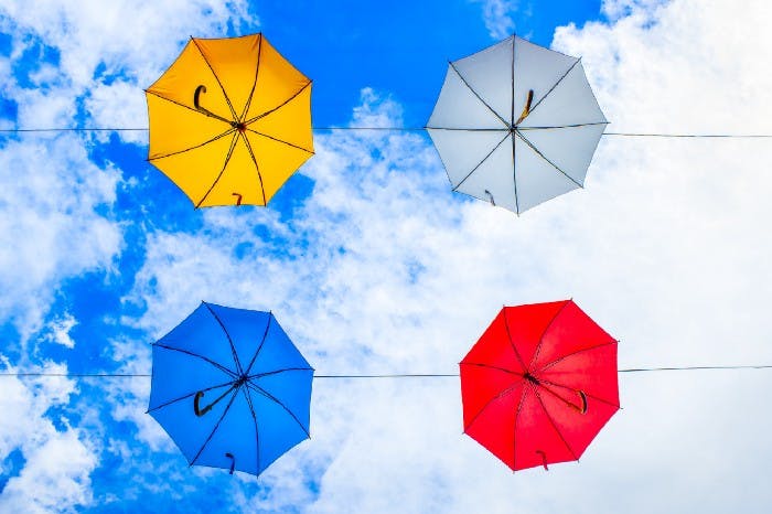 bright colored hanging umbrellas against a beautiful blue sky