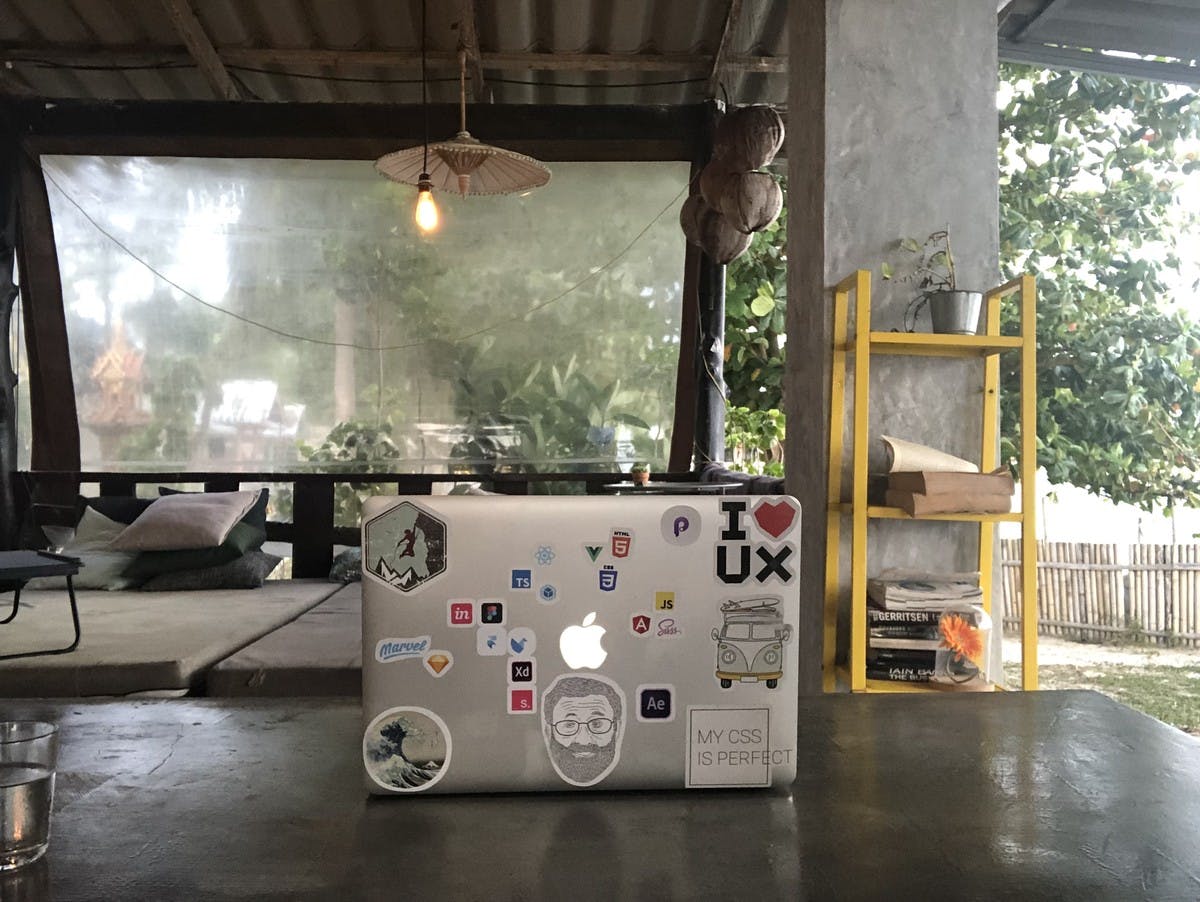 macbook in coworking space by the beach