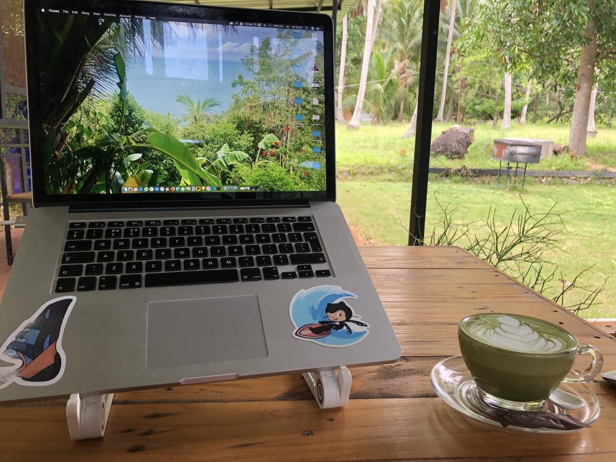matcha latte and macbook in coffee shop