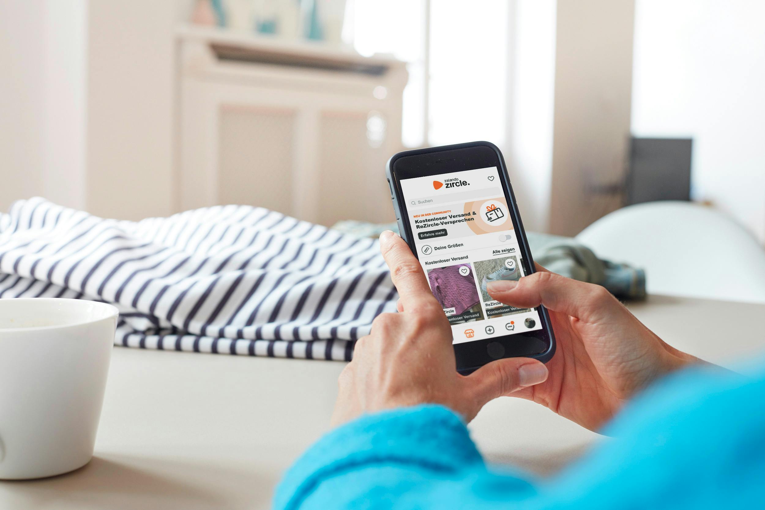 Hands holding a smartphone with Zalando app open