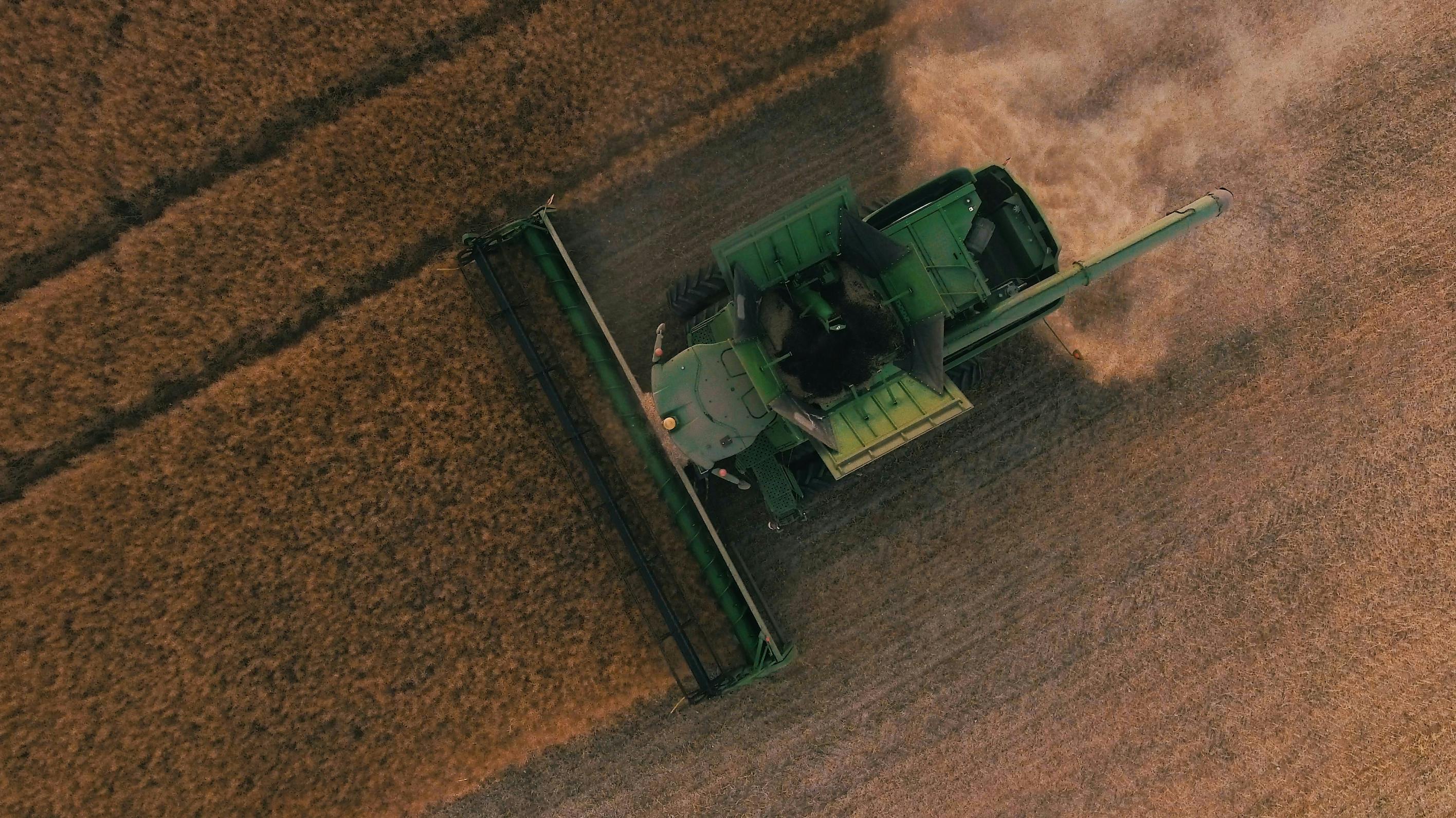 An overhead shot of a harvester working a field.