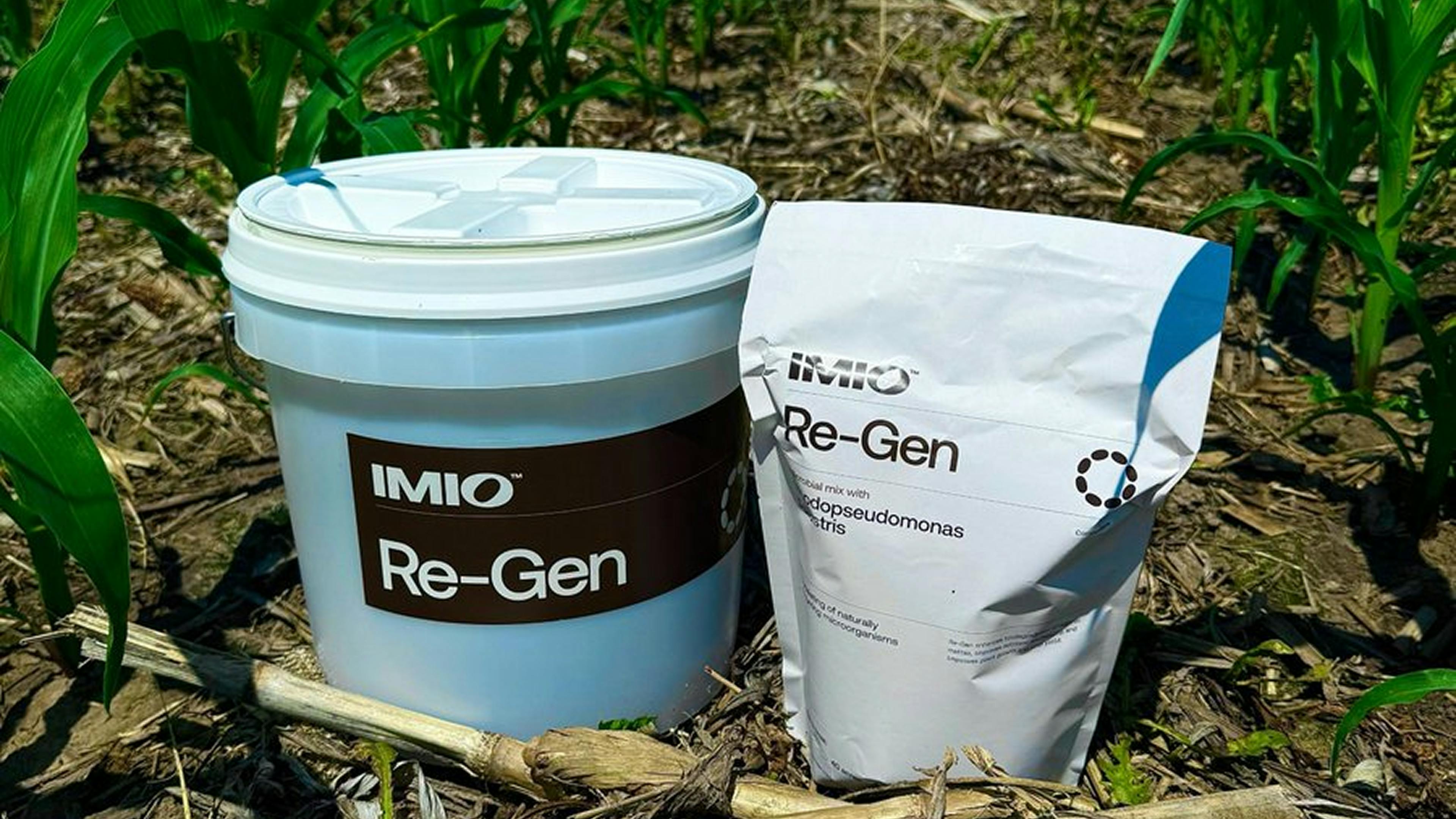 A bucket and bag of Re-Gen in a field of corn residue.