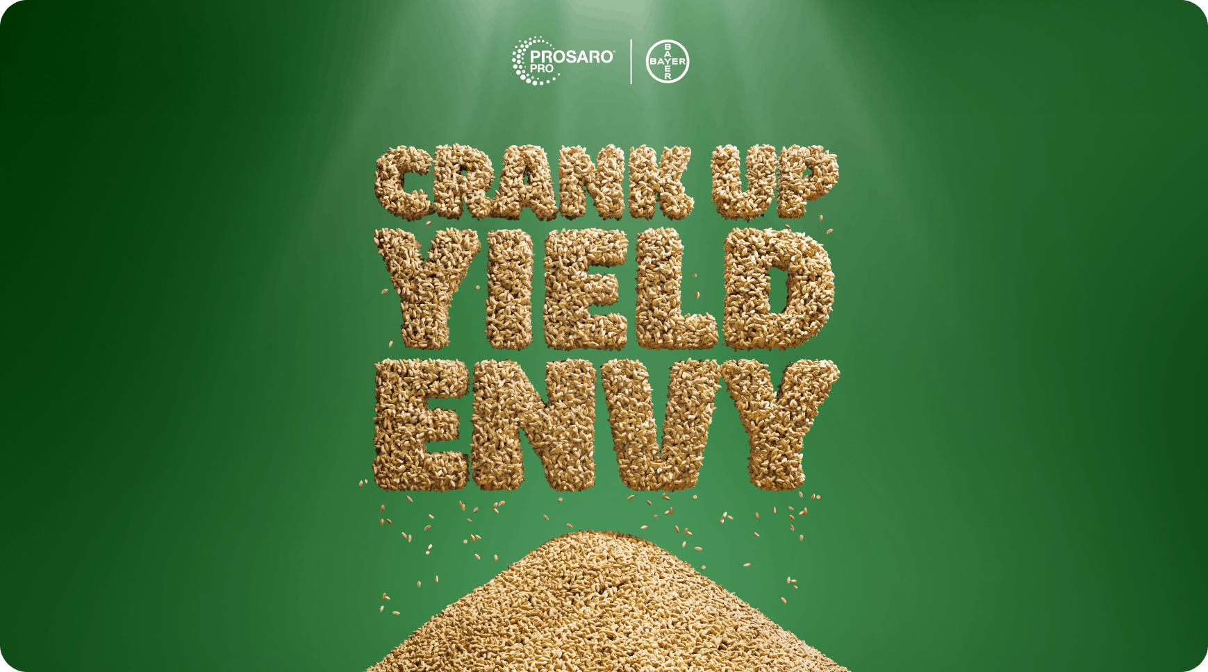 The phrase 'CRANK UP YIELD ENVY' formed with wheat seeds, above a pile of wheat seeds against a green background.
