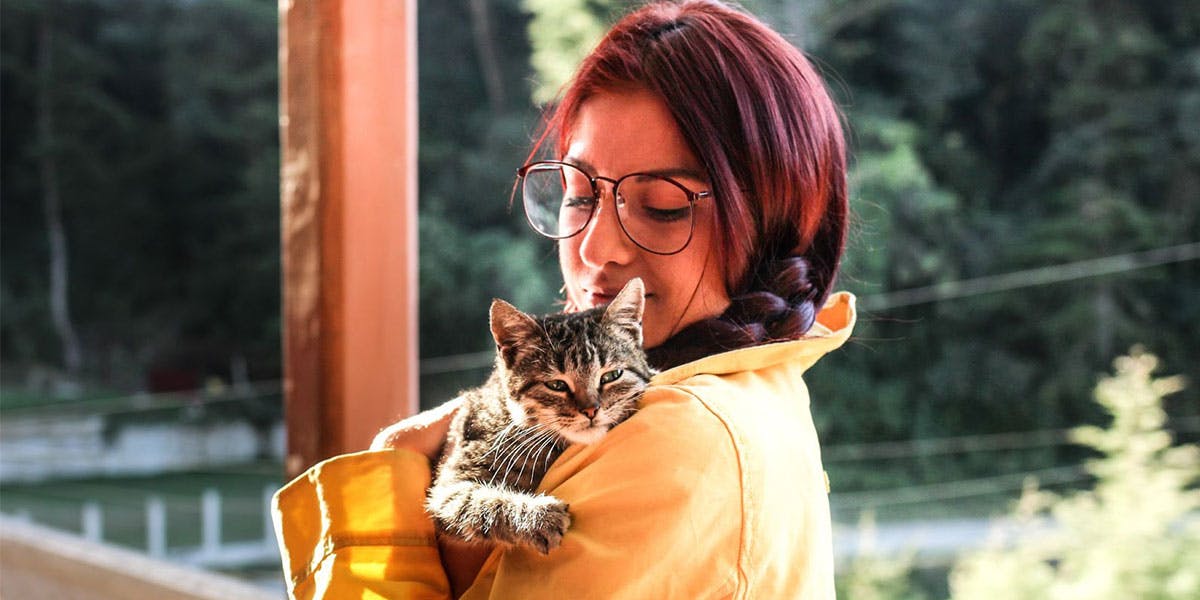 A photo of a woman holding a cat