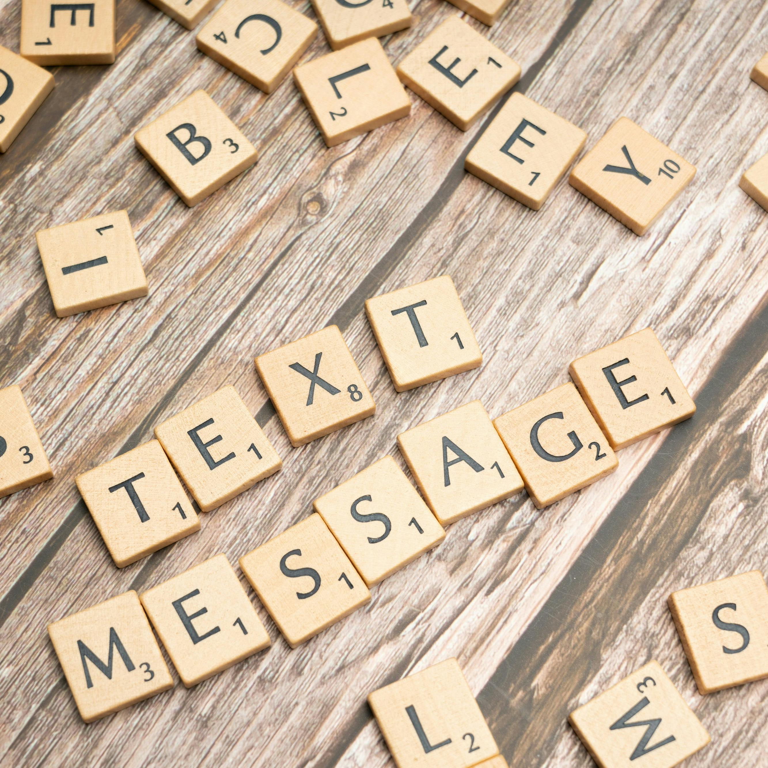 scrabble tiles spelling out Text Message