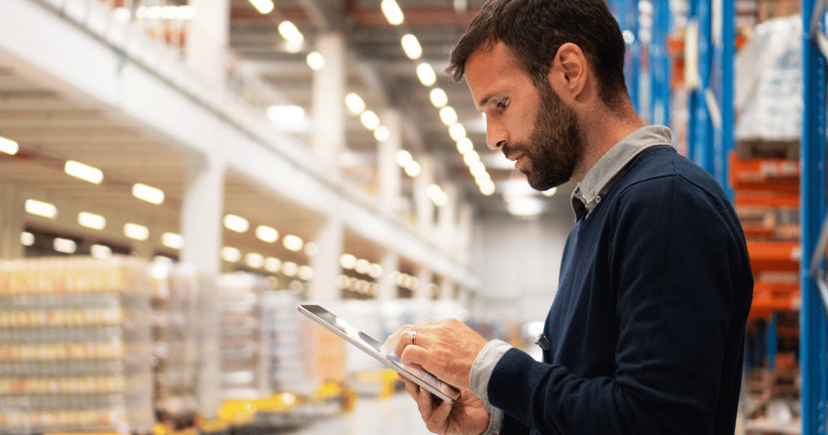 Man reviews inventory in warehouse using wifi enabled tablet - full fibre solutions to keep your business moving - Future Connected Fibre