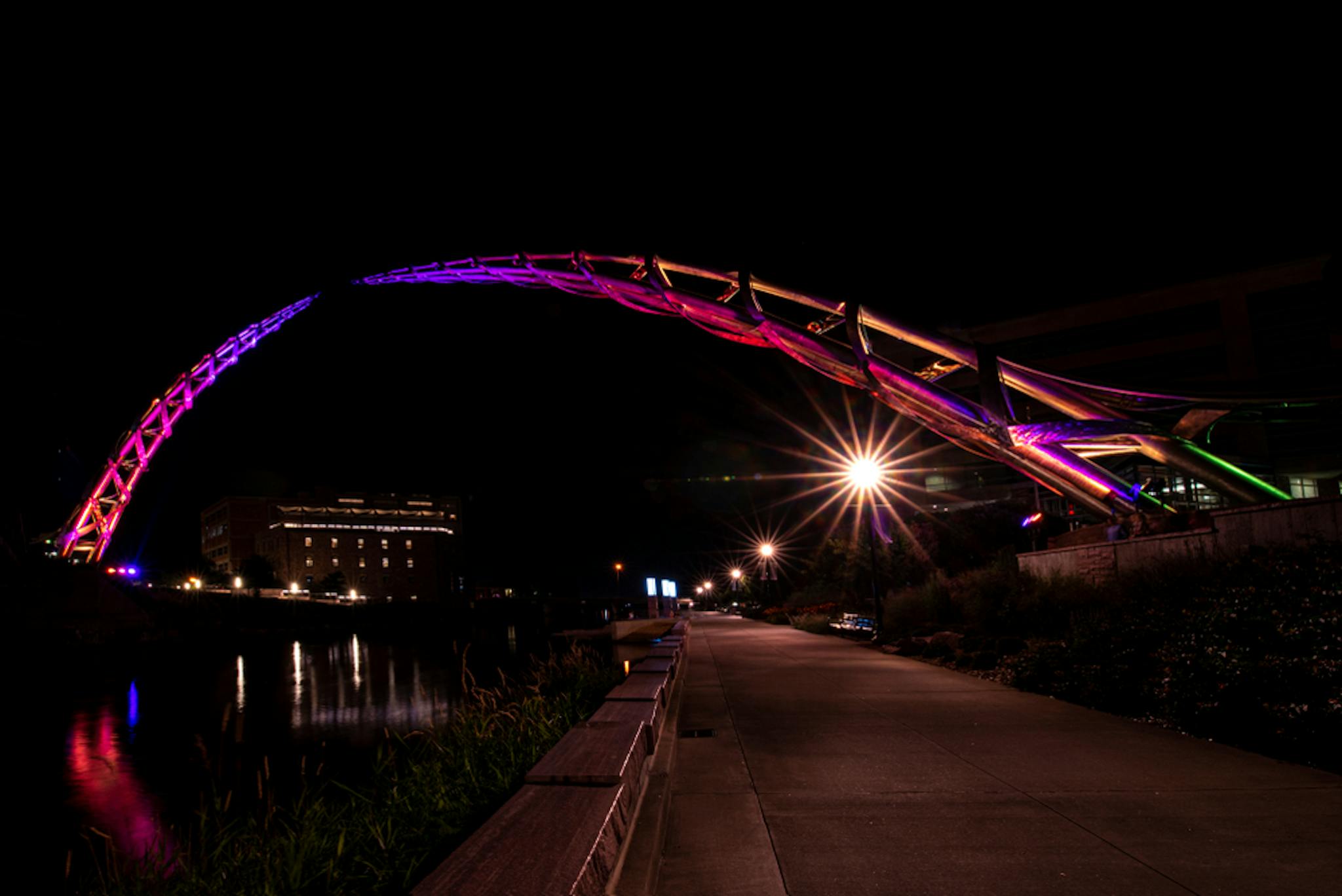 Arc of Dreams sculpture lit at night as part Sioux Falls Sculpture Walk.