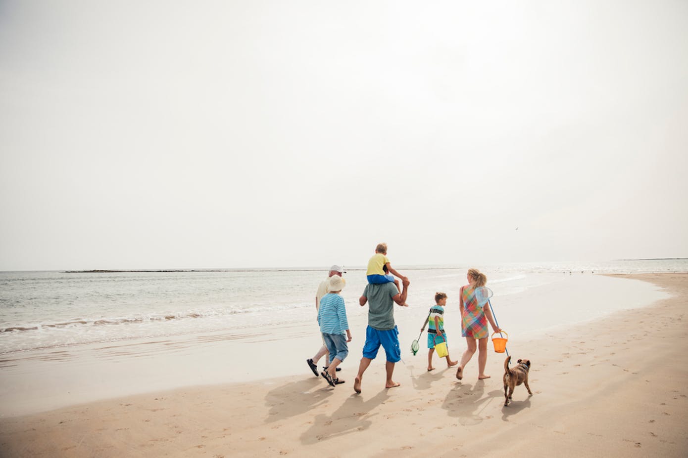 Multi-gen family vacation starts with a walk on the beach.