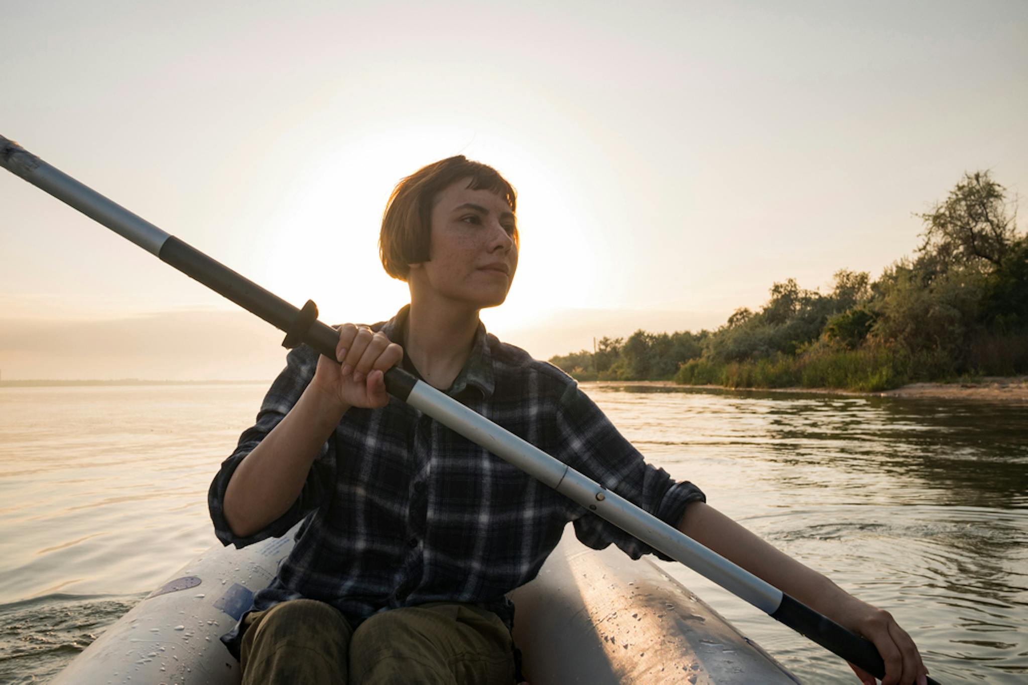 Woman kayaking across a lake in Arkansas