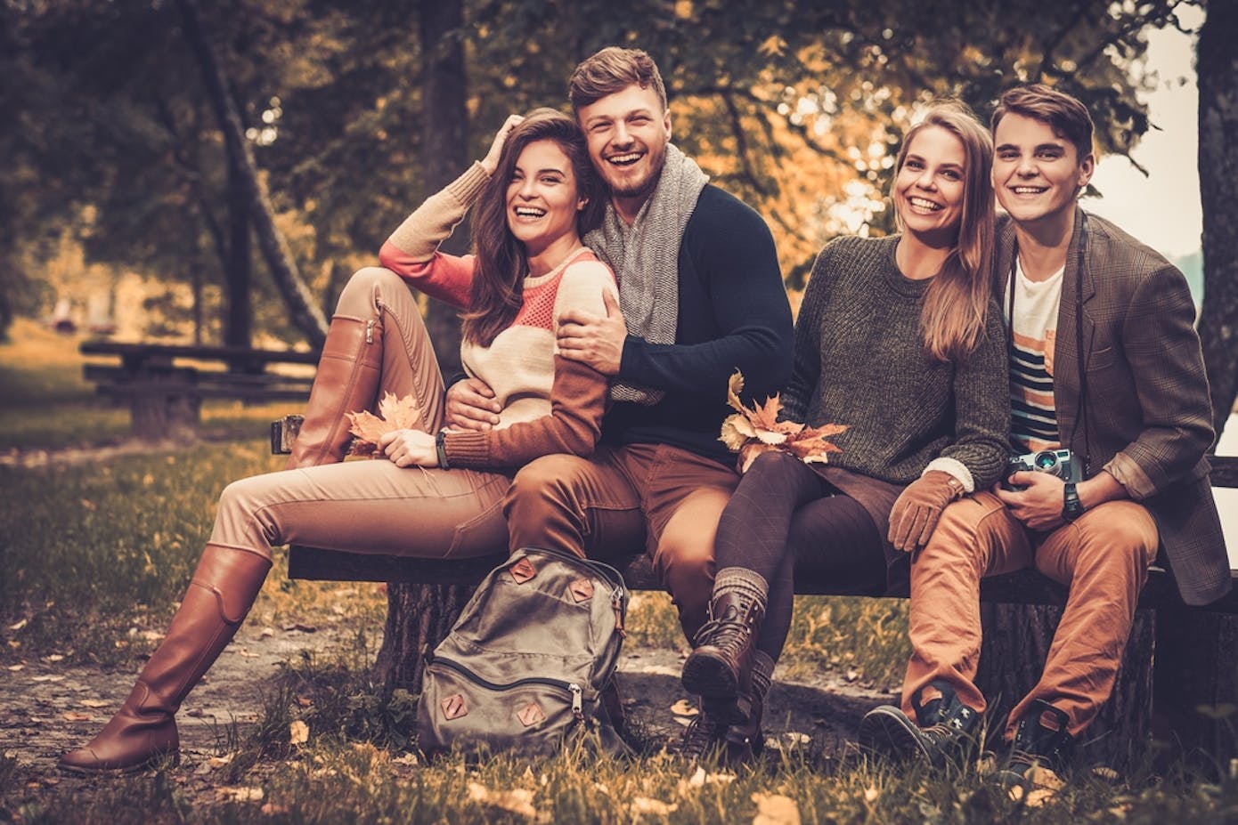 Friends posing in an autumn park.