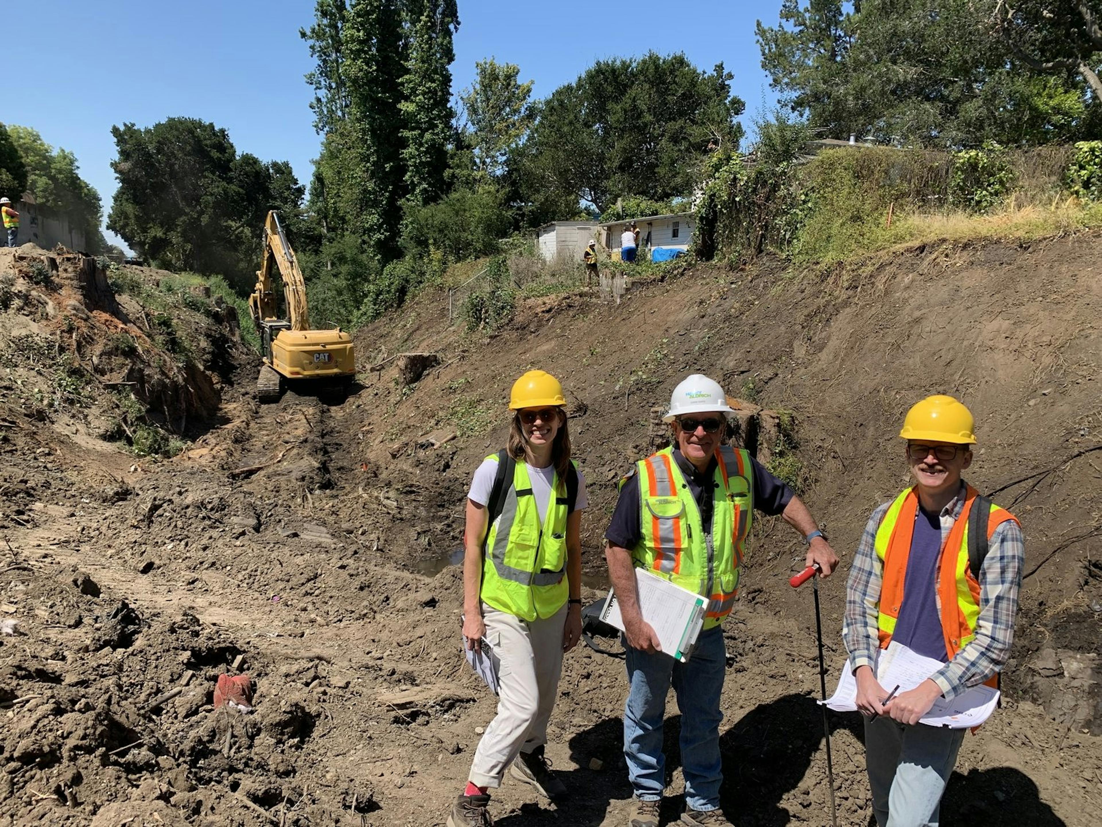 3 engineers pose for a photo at the job site