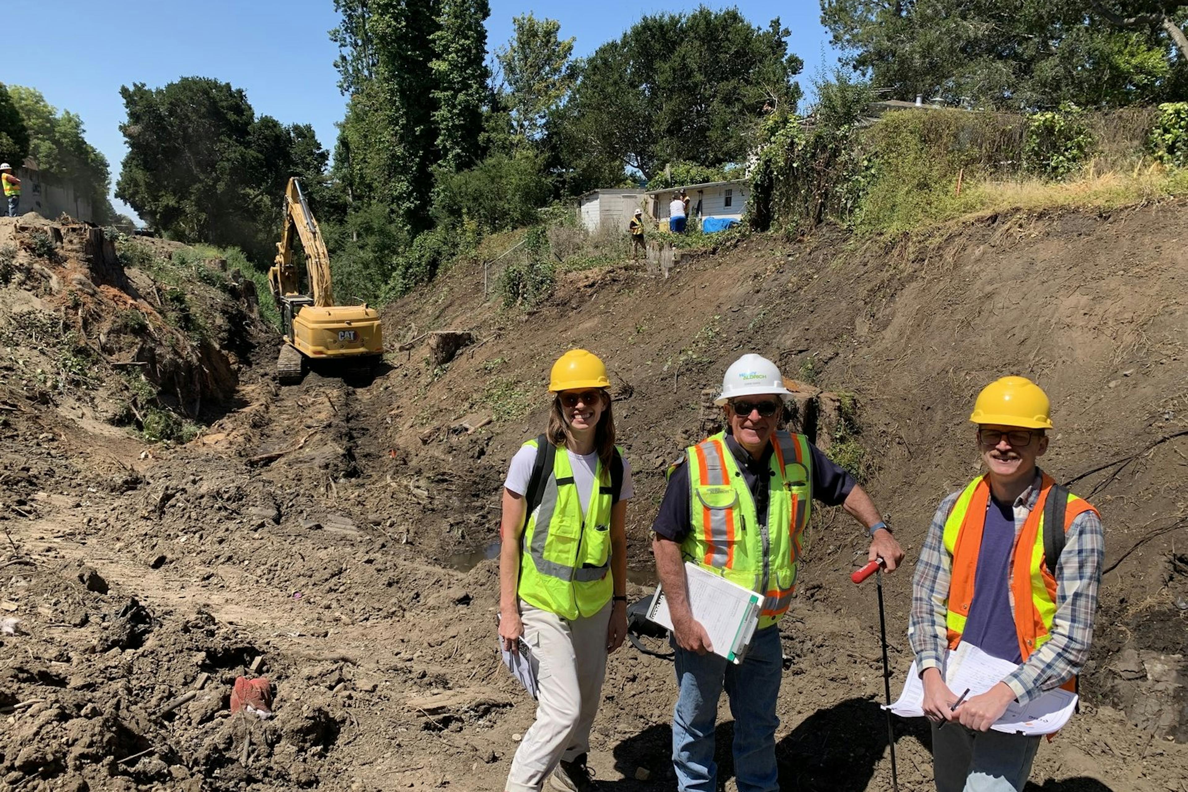 3 engineers pose for a photo at the job site
