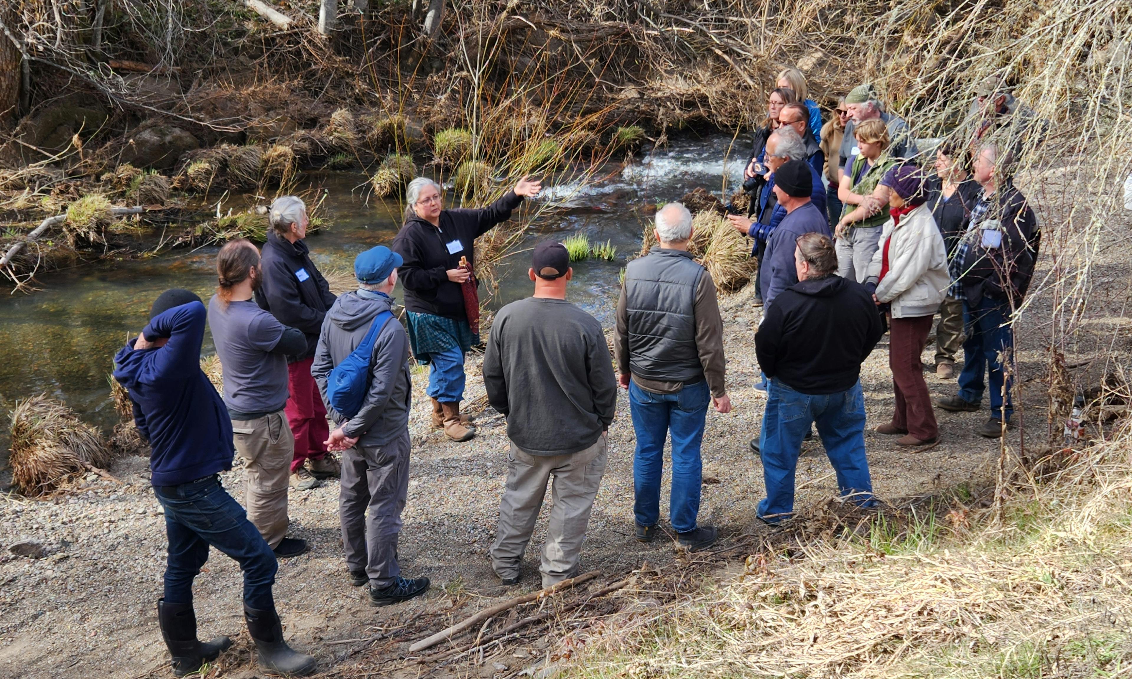 group of people standing near a river in Clear Lake