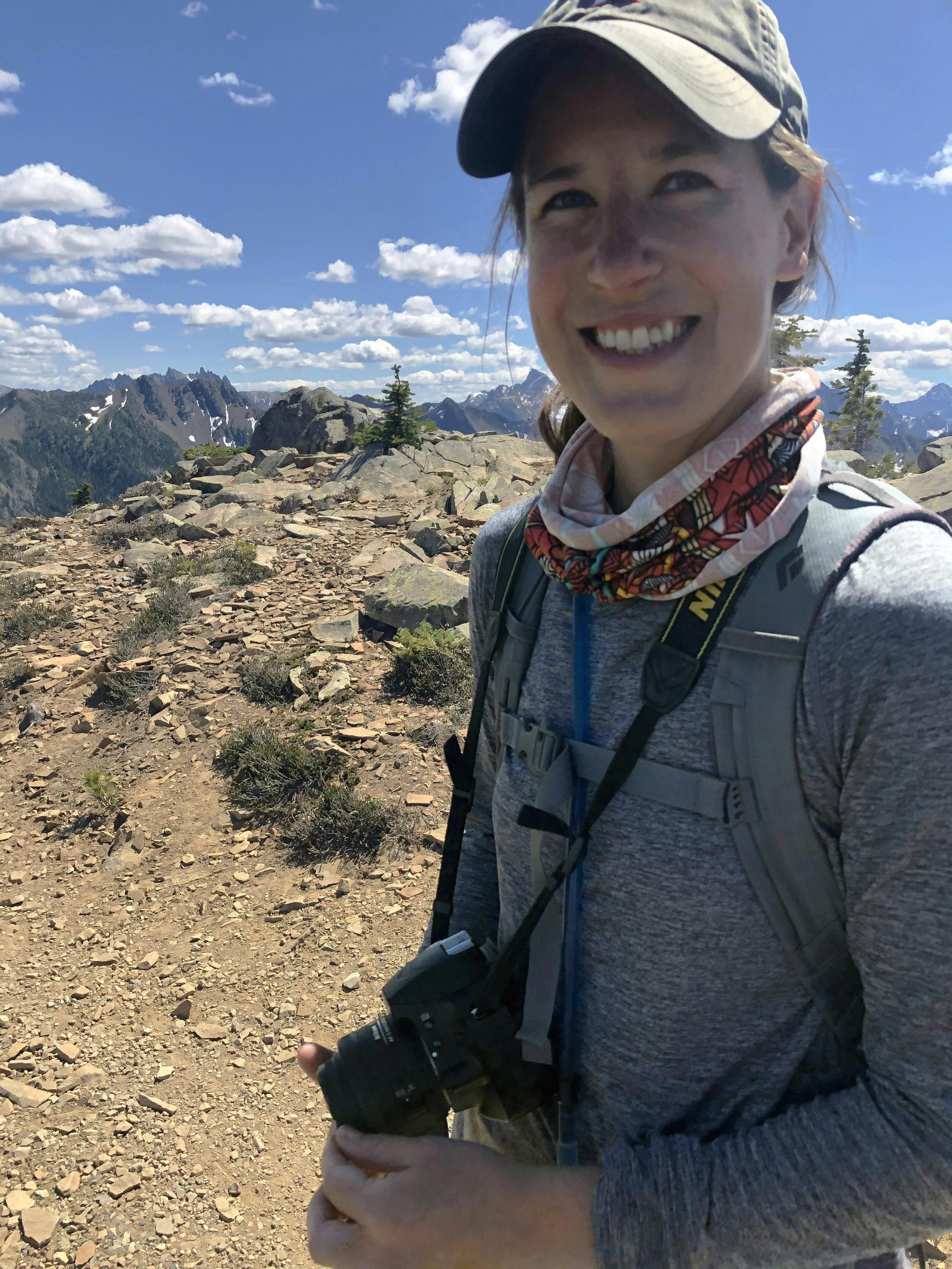 woman holding binoculars with a desert background