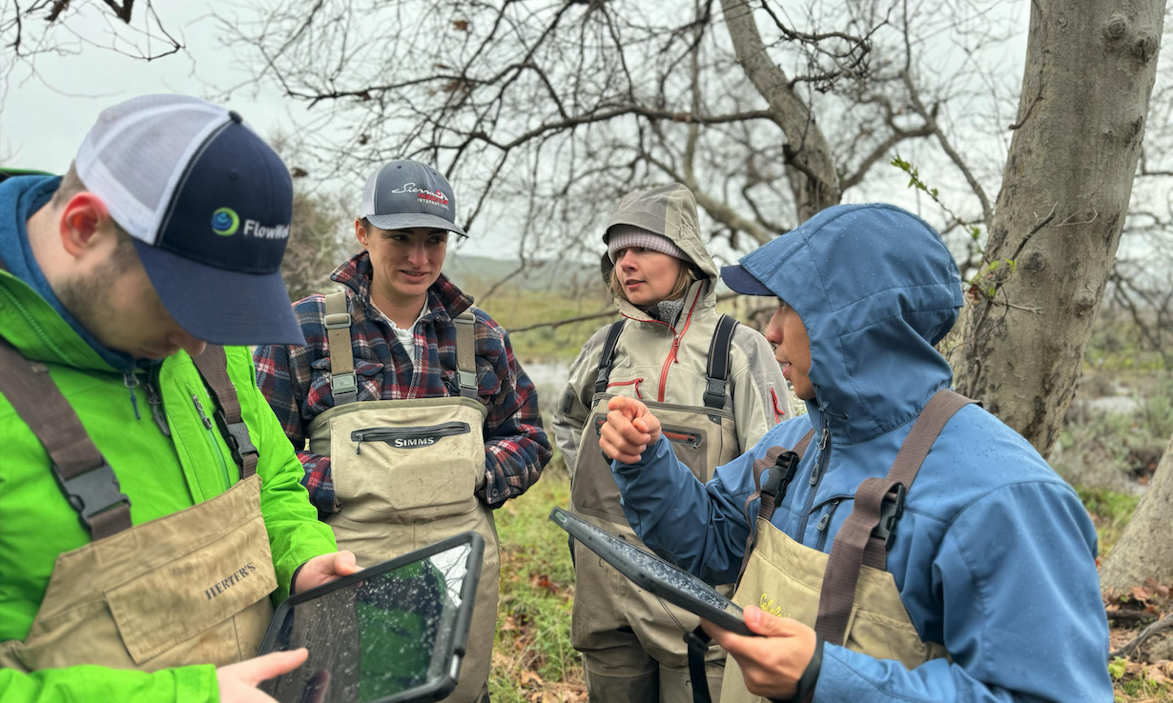 The FlowWest team meets with the client to see their tablet application in action.