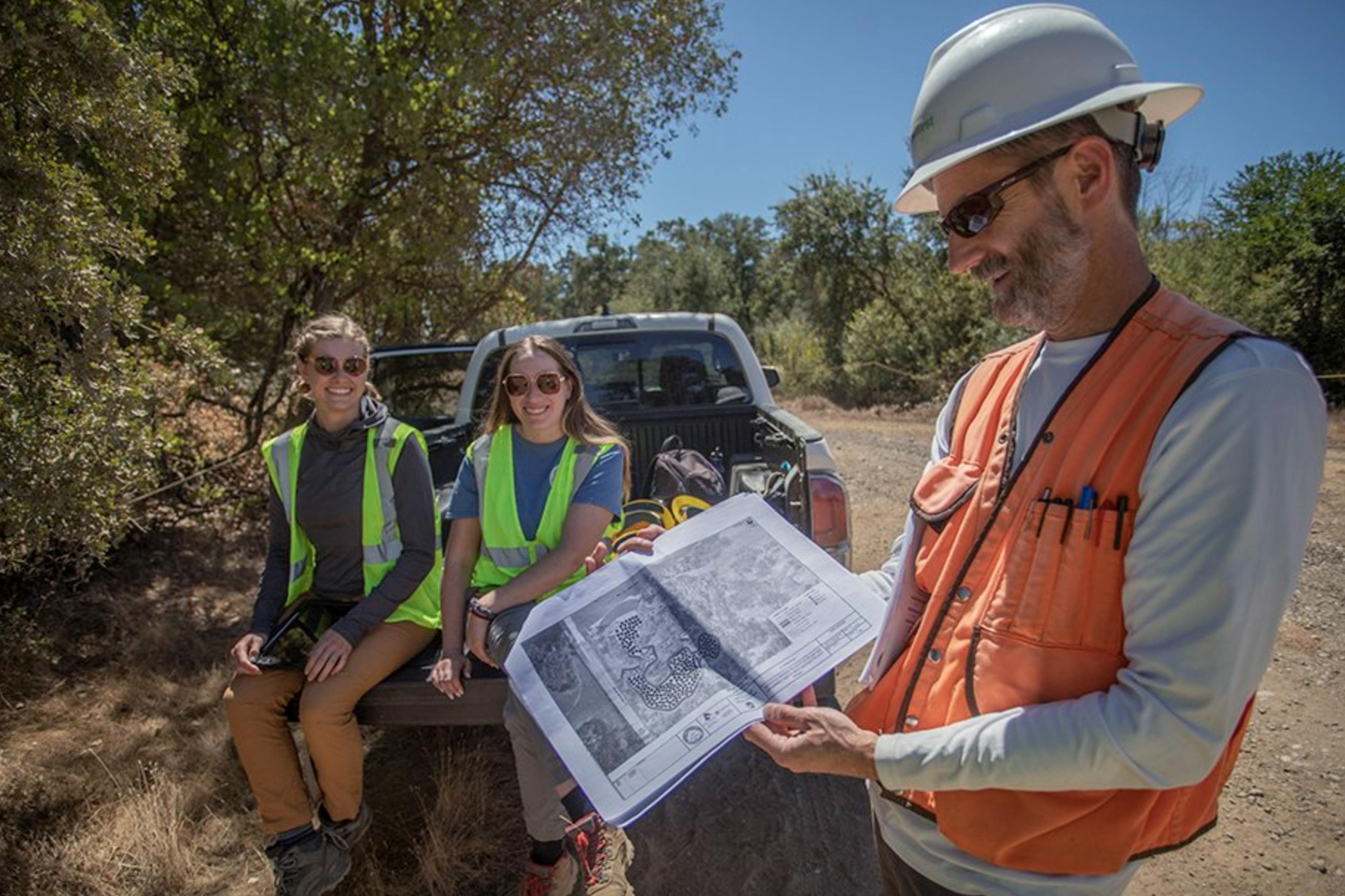 Mark Tompkins looks over floodplain restoration design plans.