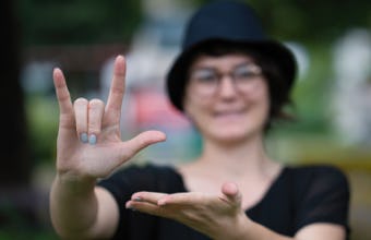 Young woman using sign language.