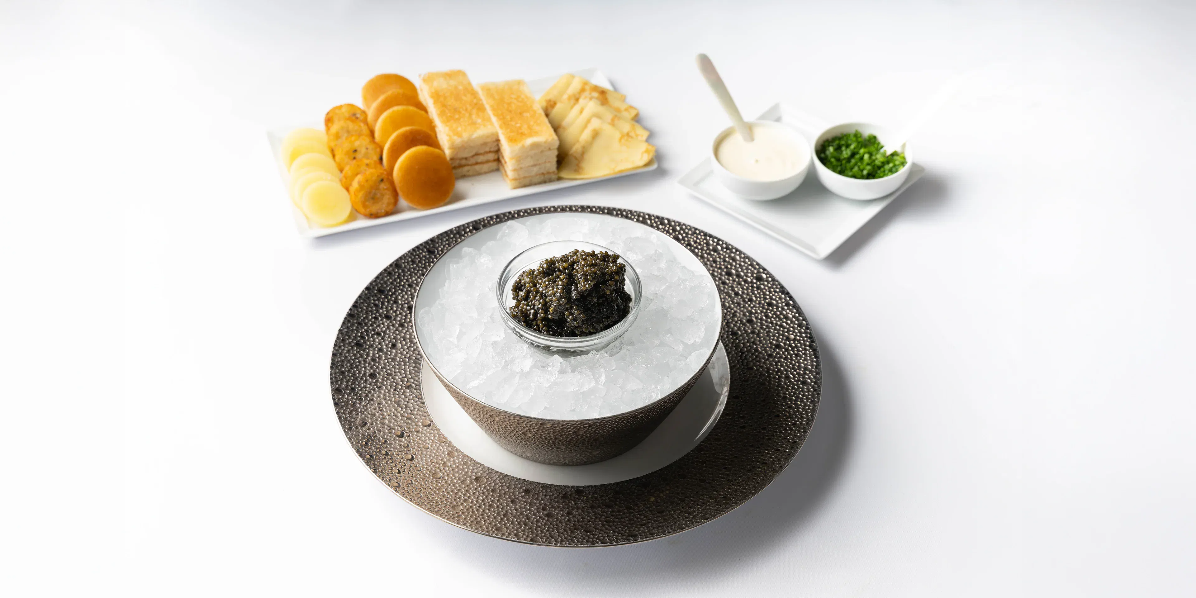 Elegant plated dessert served with pastries and a small side dish.