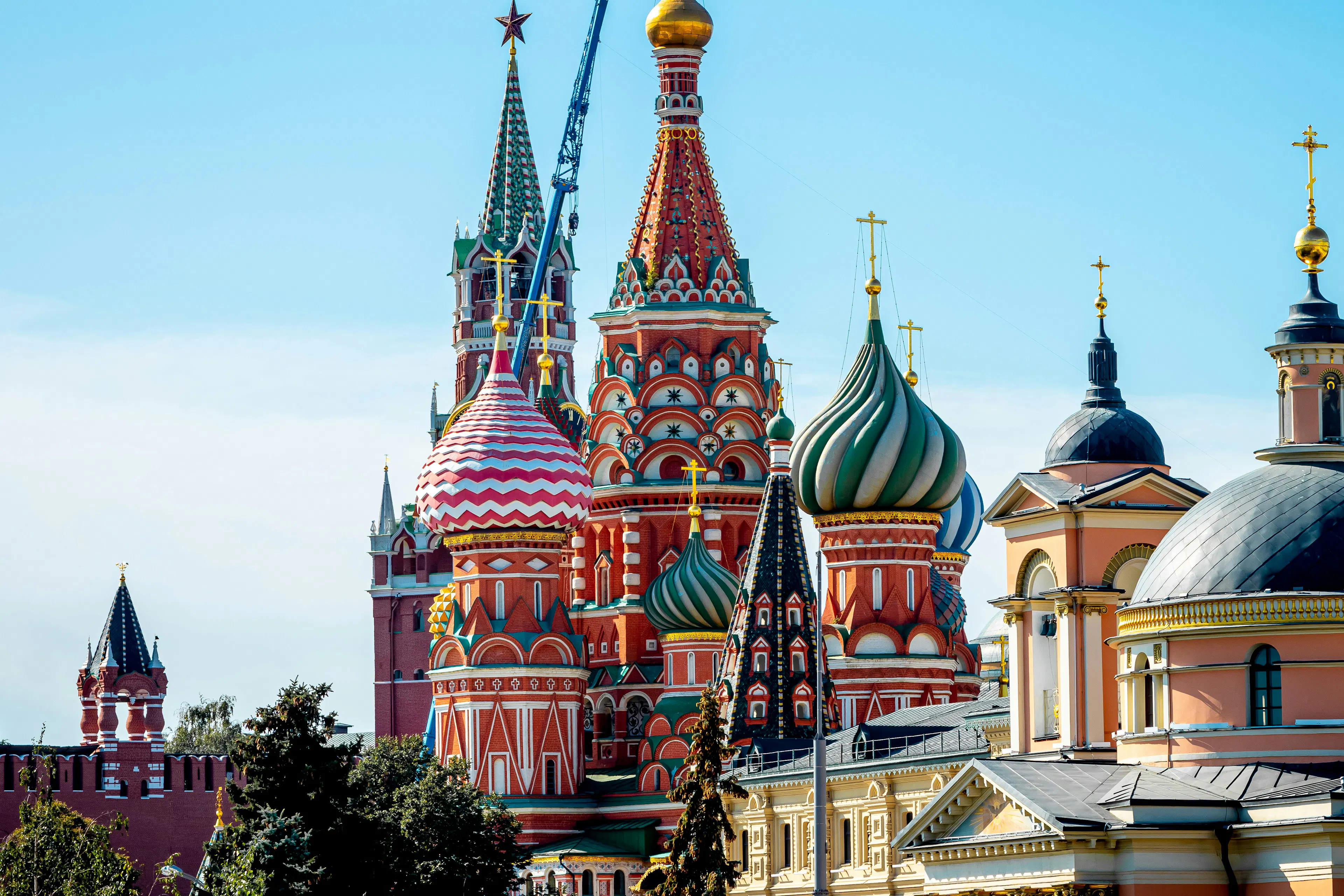 Colorful domes and towers of Saint Basil’s Cathedral in Moscow under a clear blue sky.