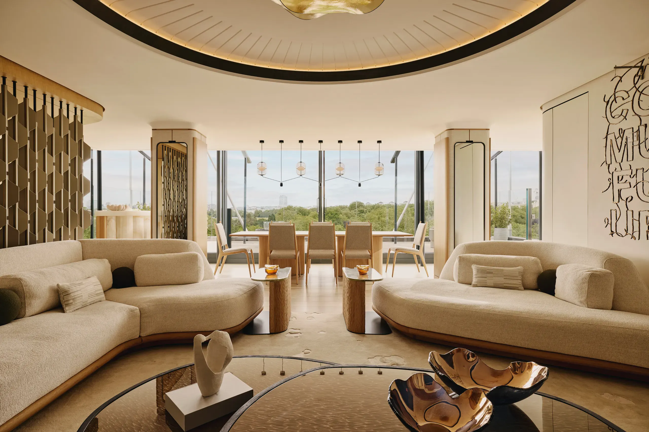 Elegant living room with curved sofas and floor-to-ceiling windows.