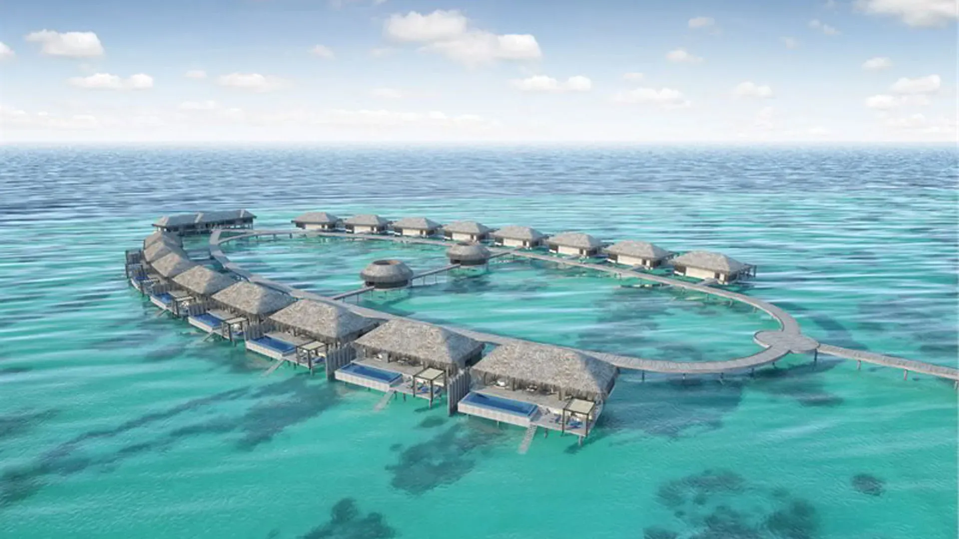 Overwater villas arranged above clear turquoise ocean waters.