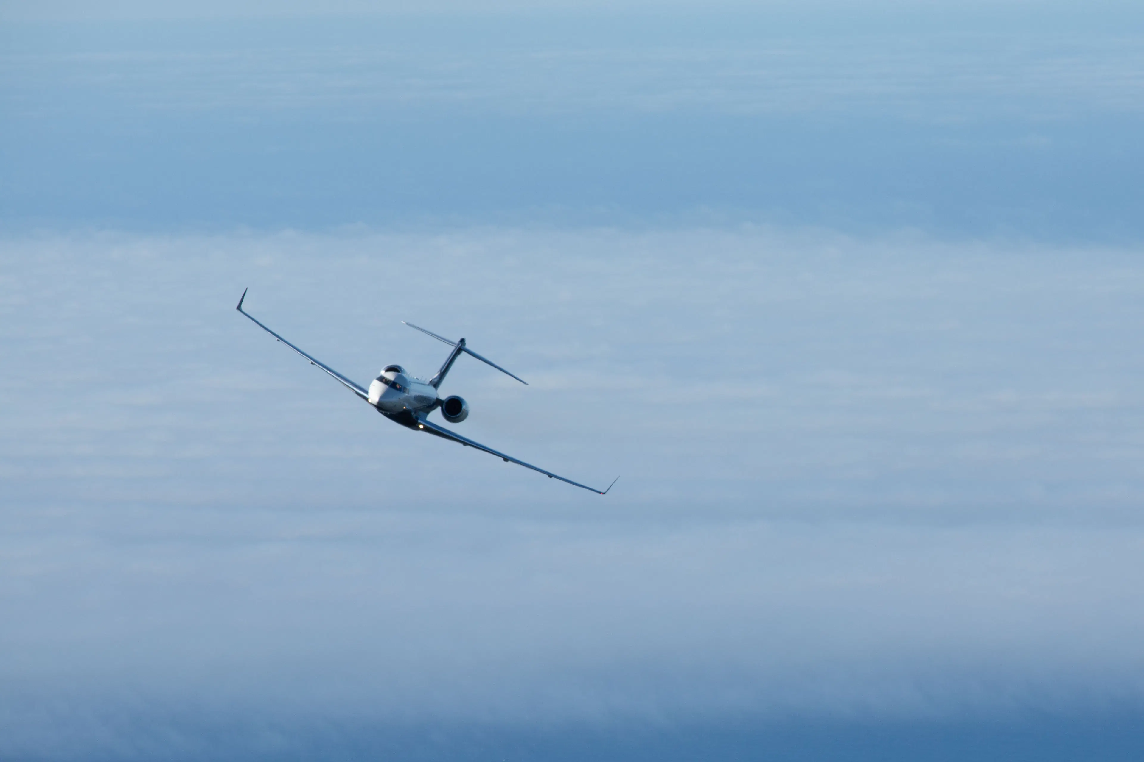 Private jet flying above the clouds