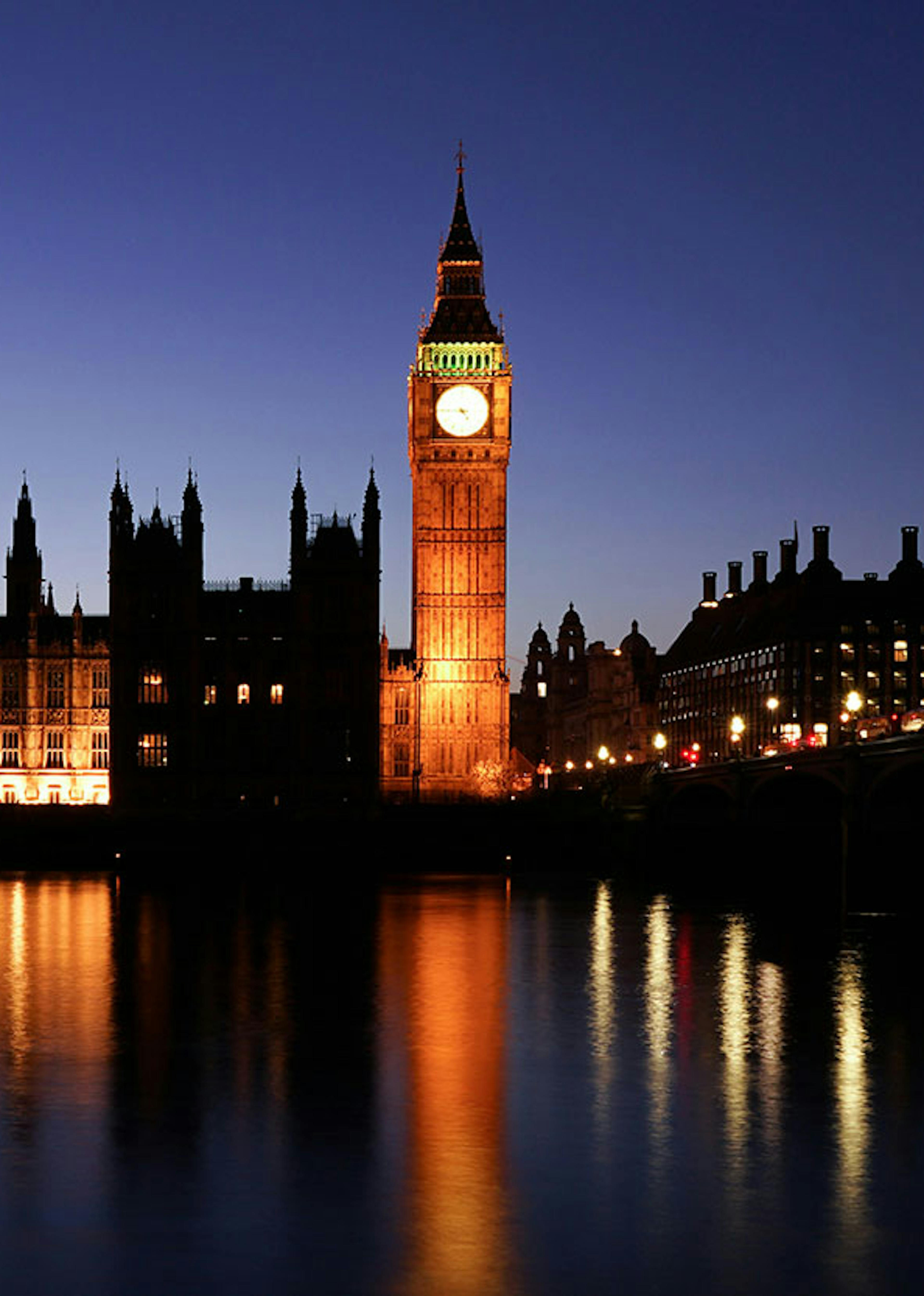 The big ben clock at night illuminated from lights below