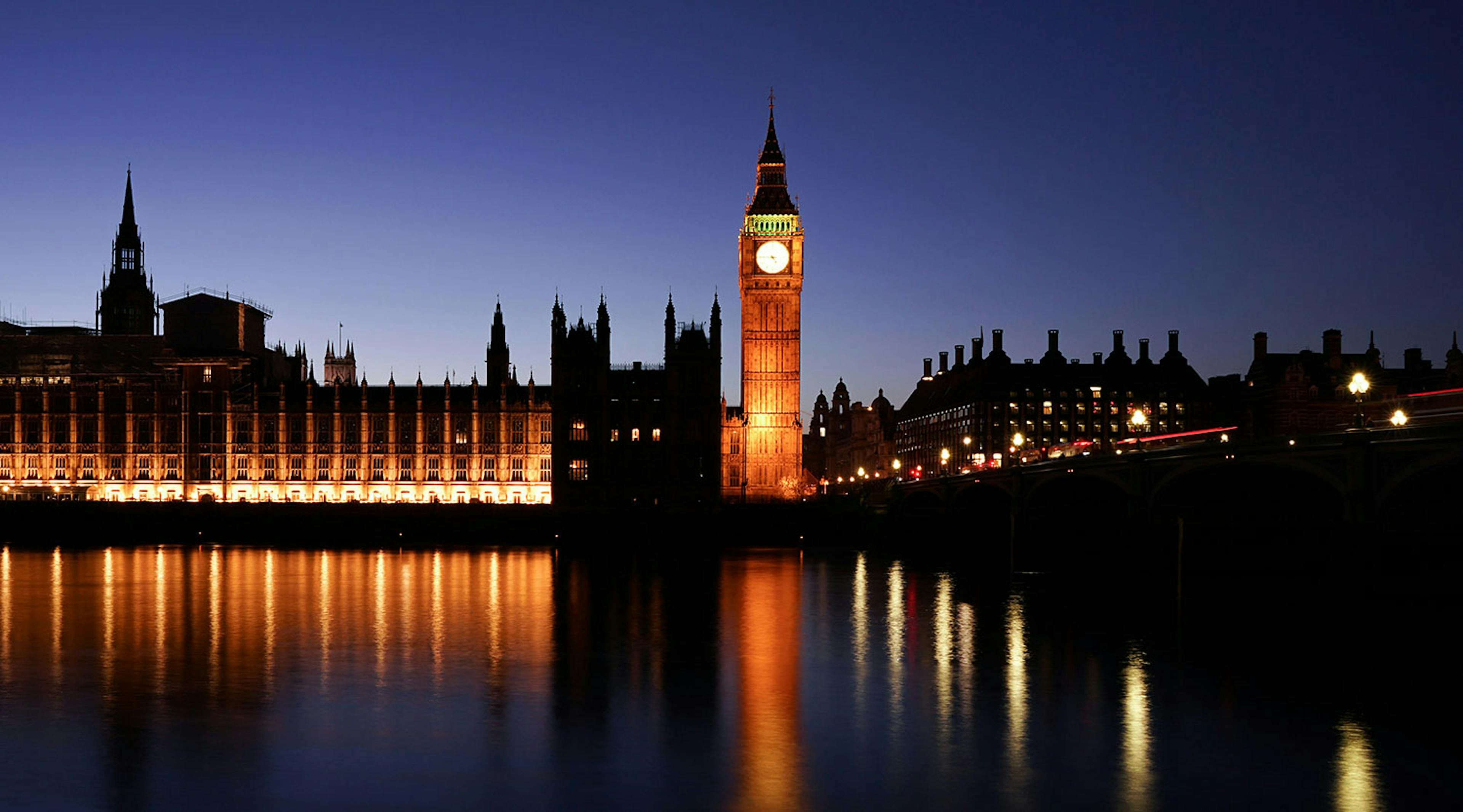 The big ben clock at night illuminated from lights below