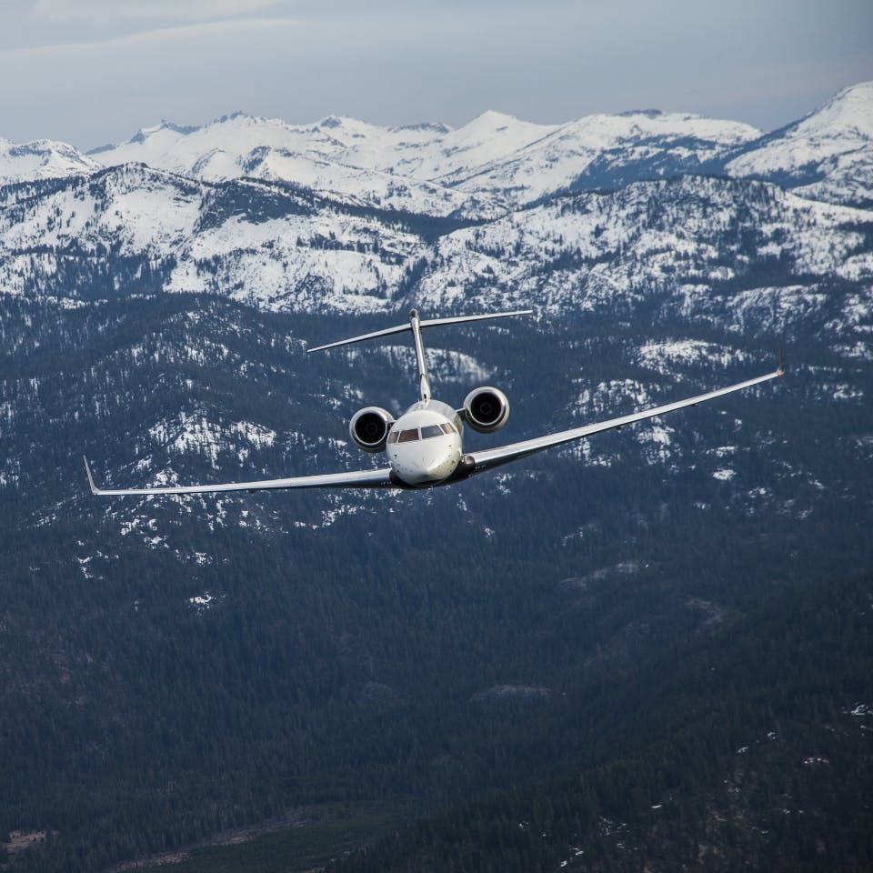 Global Express flying over mountains