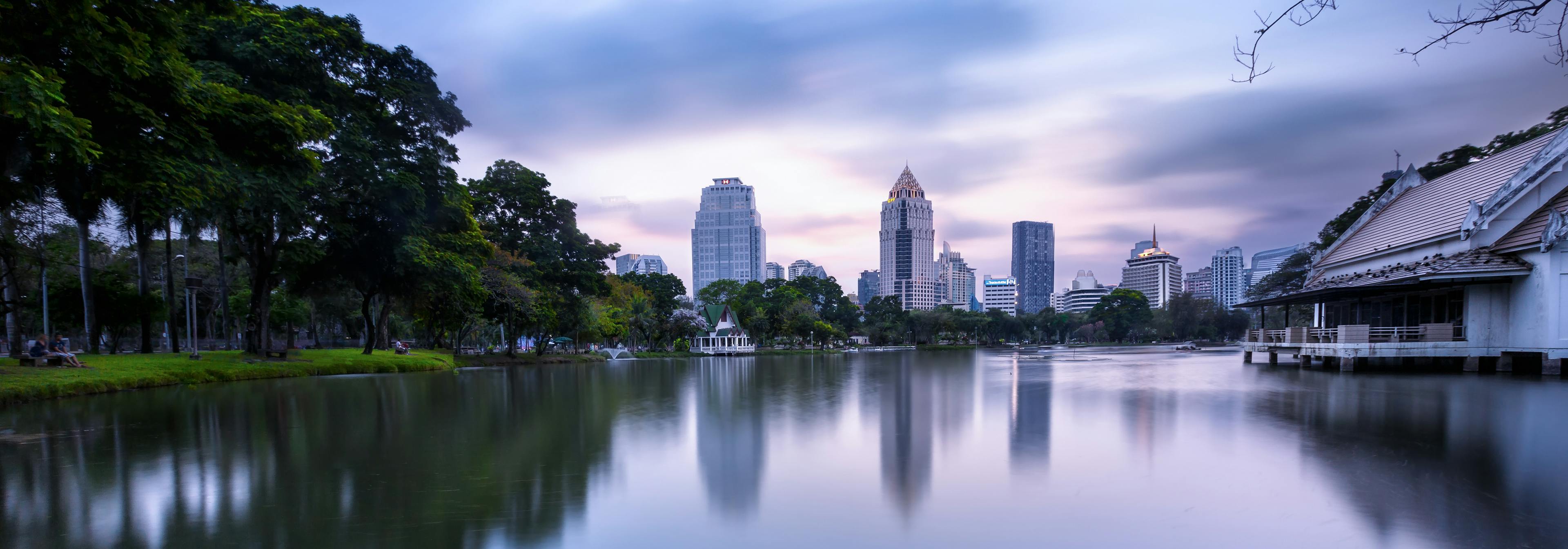 A lake with a view of some buildings from the Houston skyline