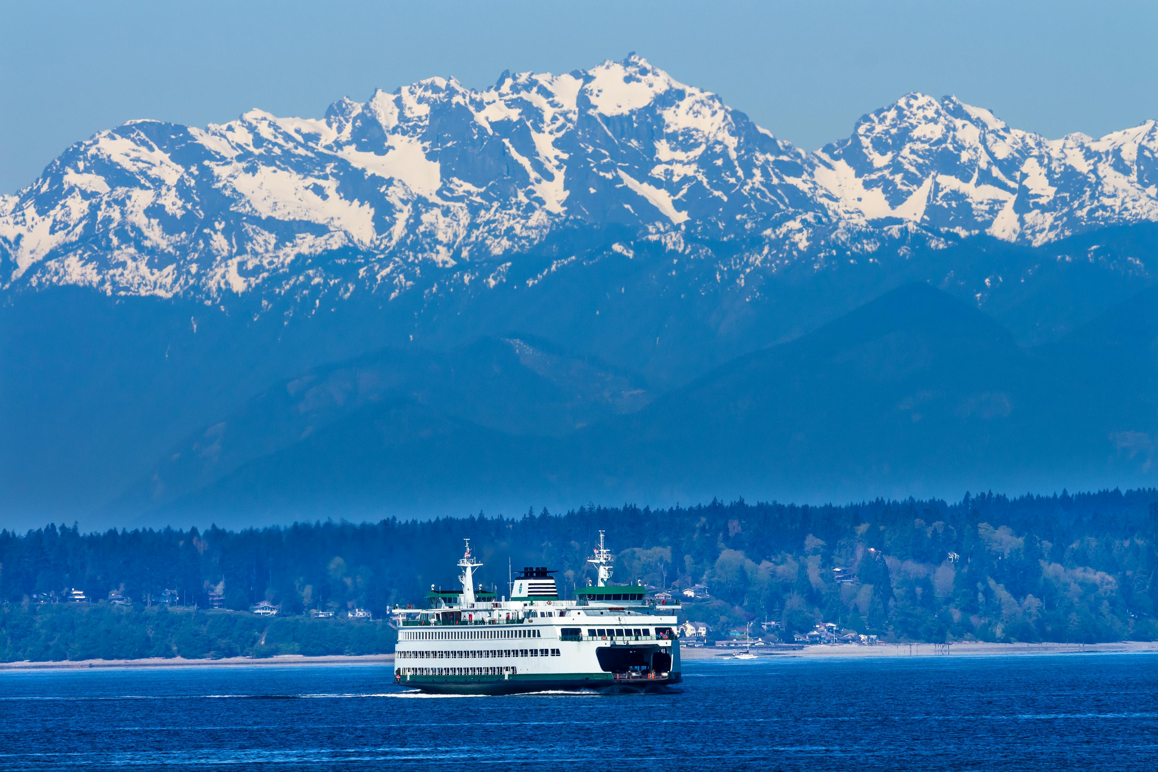 Ferry boat in the sound with mountains on the horizon