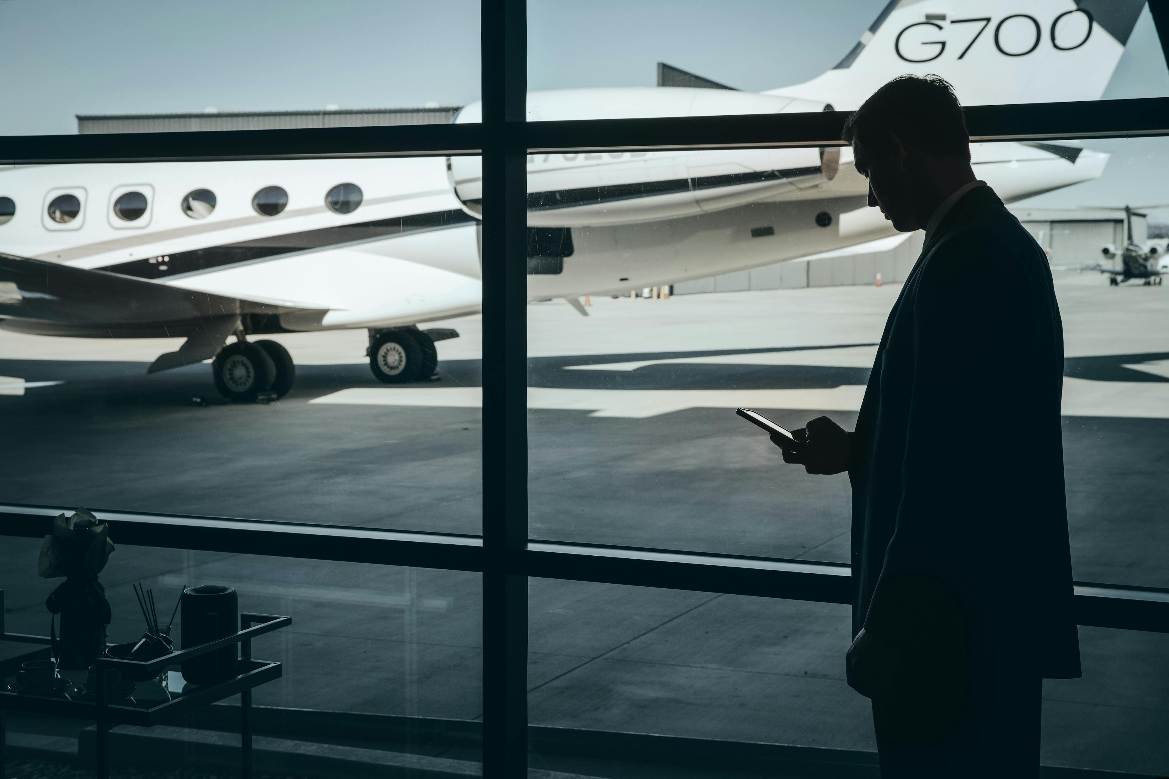 Flight Advisor checking phone in front of Gulfstream G700