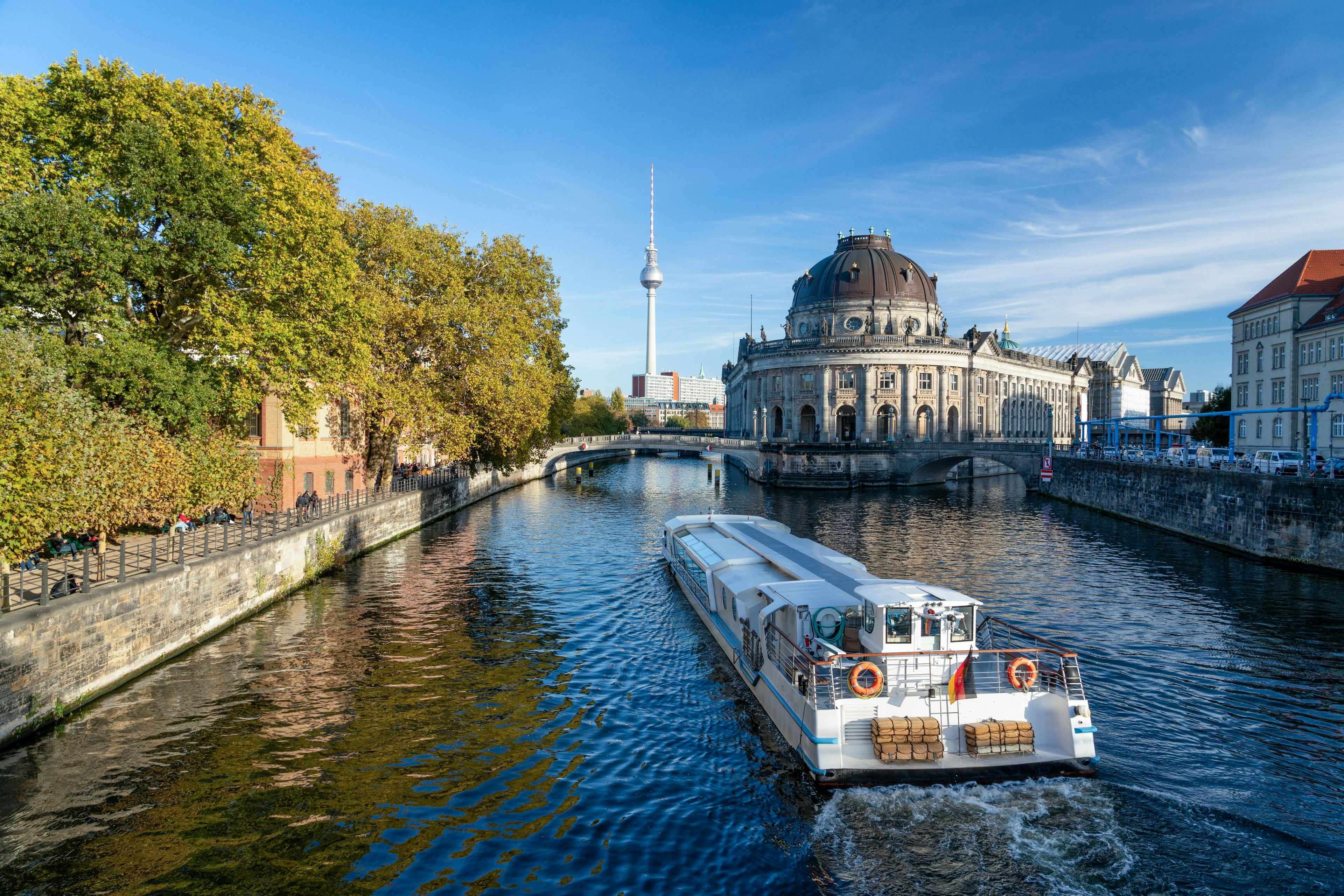 A boat cruising through the river through Berlin