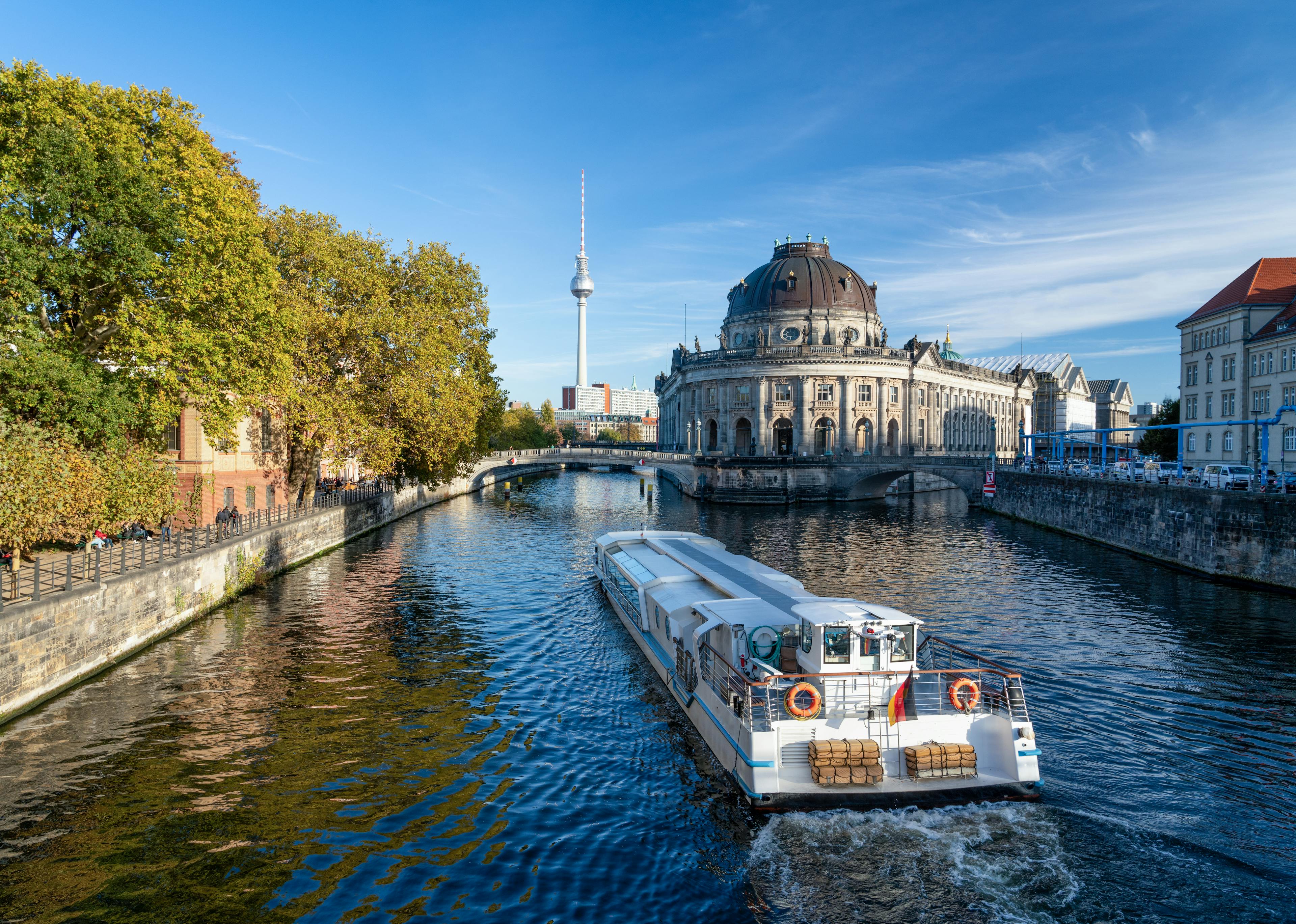 A boat cruising through the river through Berlin