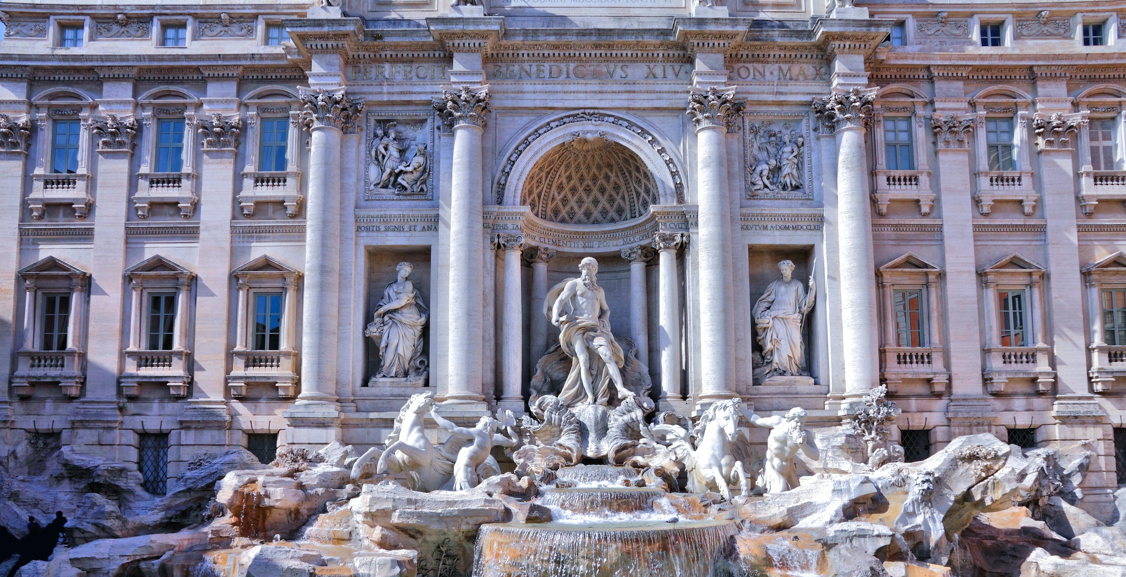 Statues and a fountain in front of an ornate building