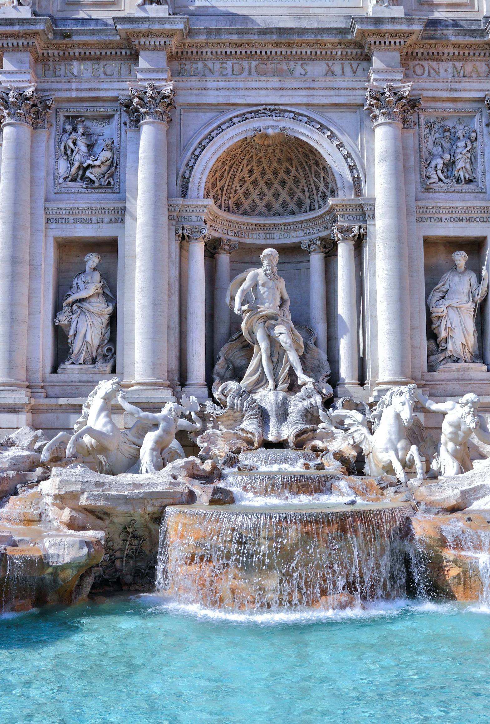 Statues and a fountain in front of an ornate building