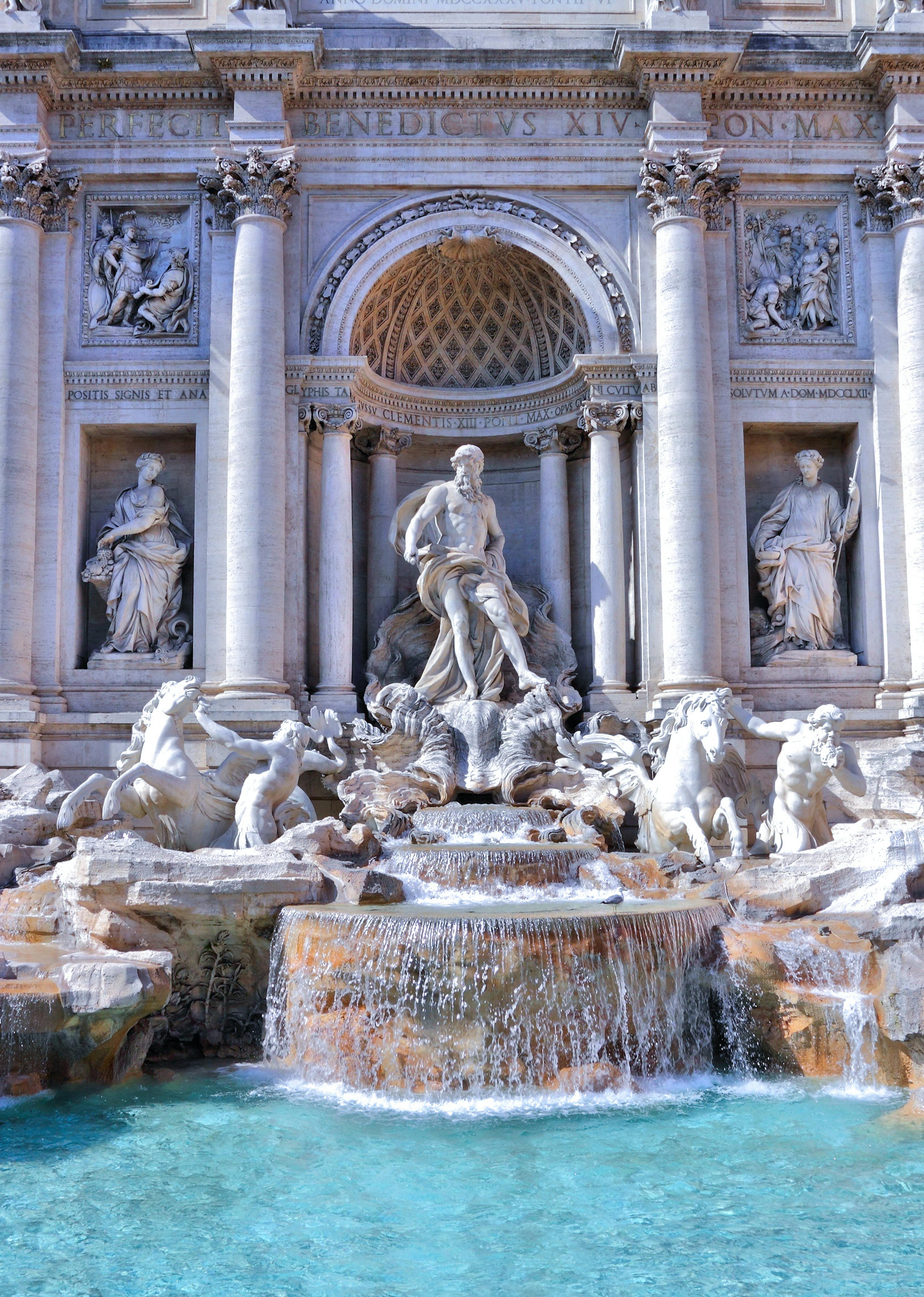 Statues and a fountain in front of an ornate building