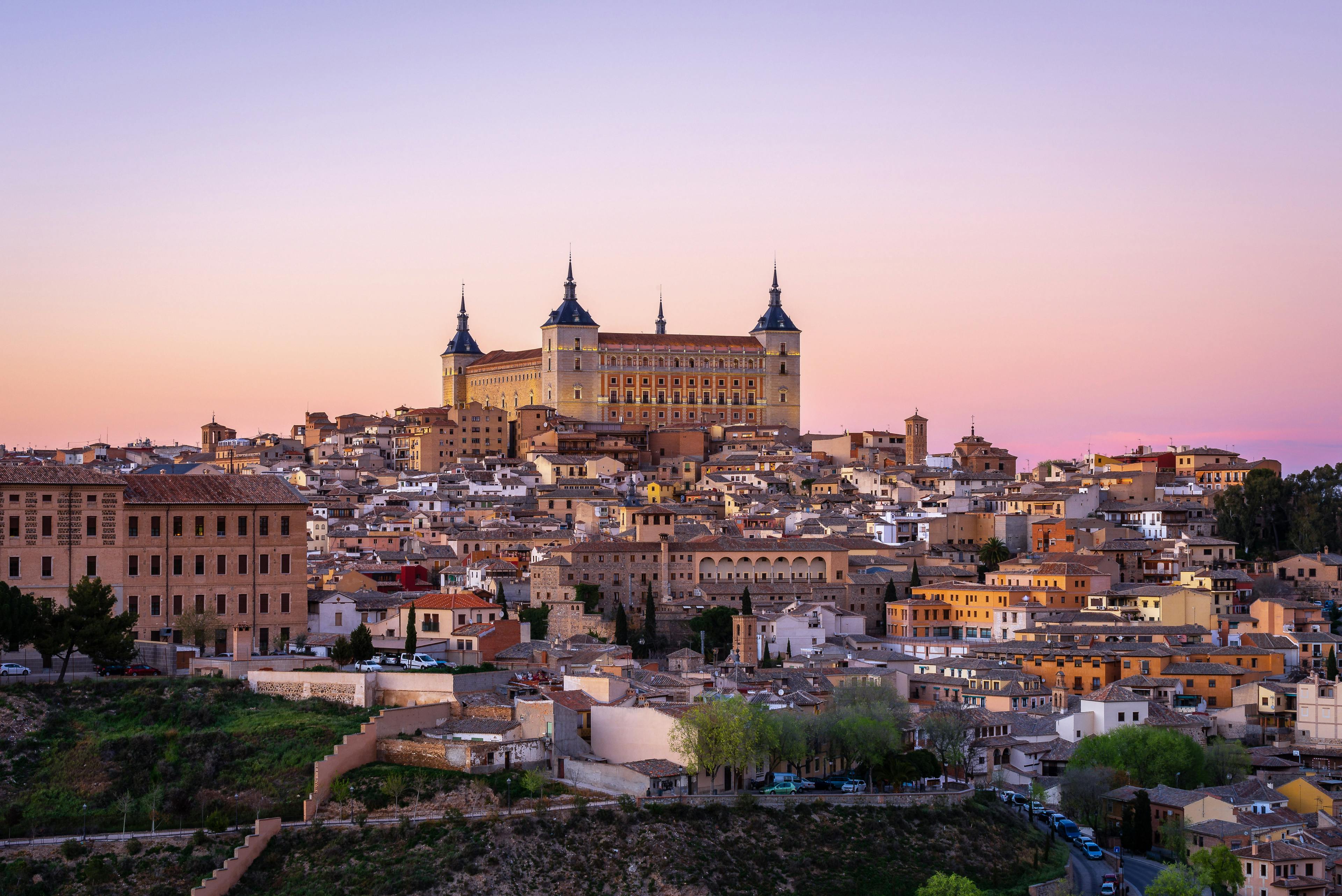 Hillside of smaller buildings topped with a large ornate building