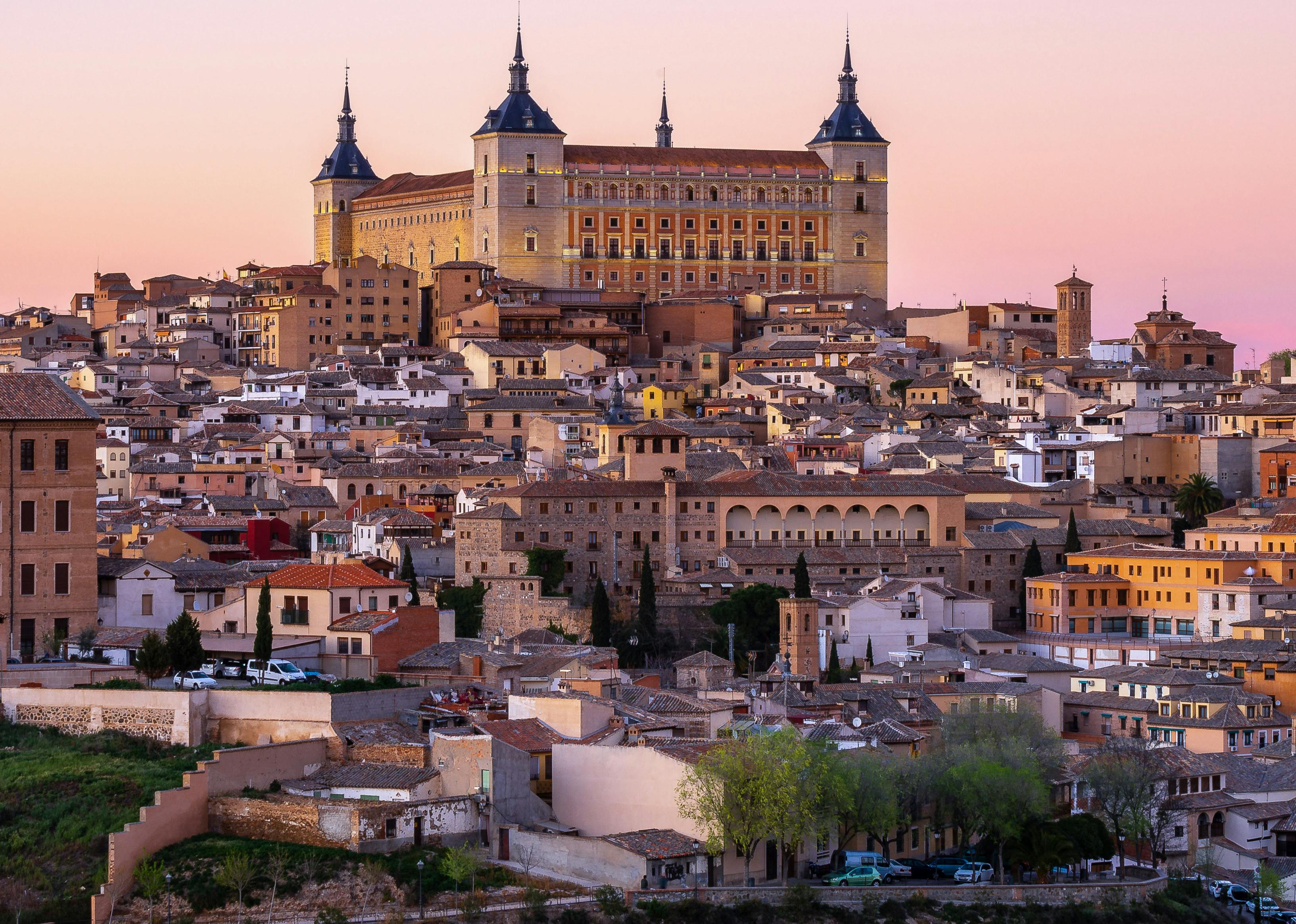 Hillside of smaller buildings topped with a large ornate building