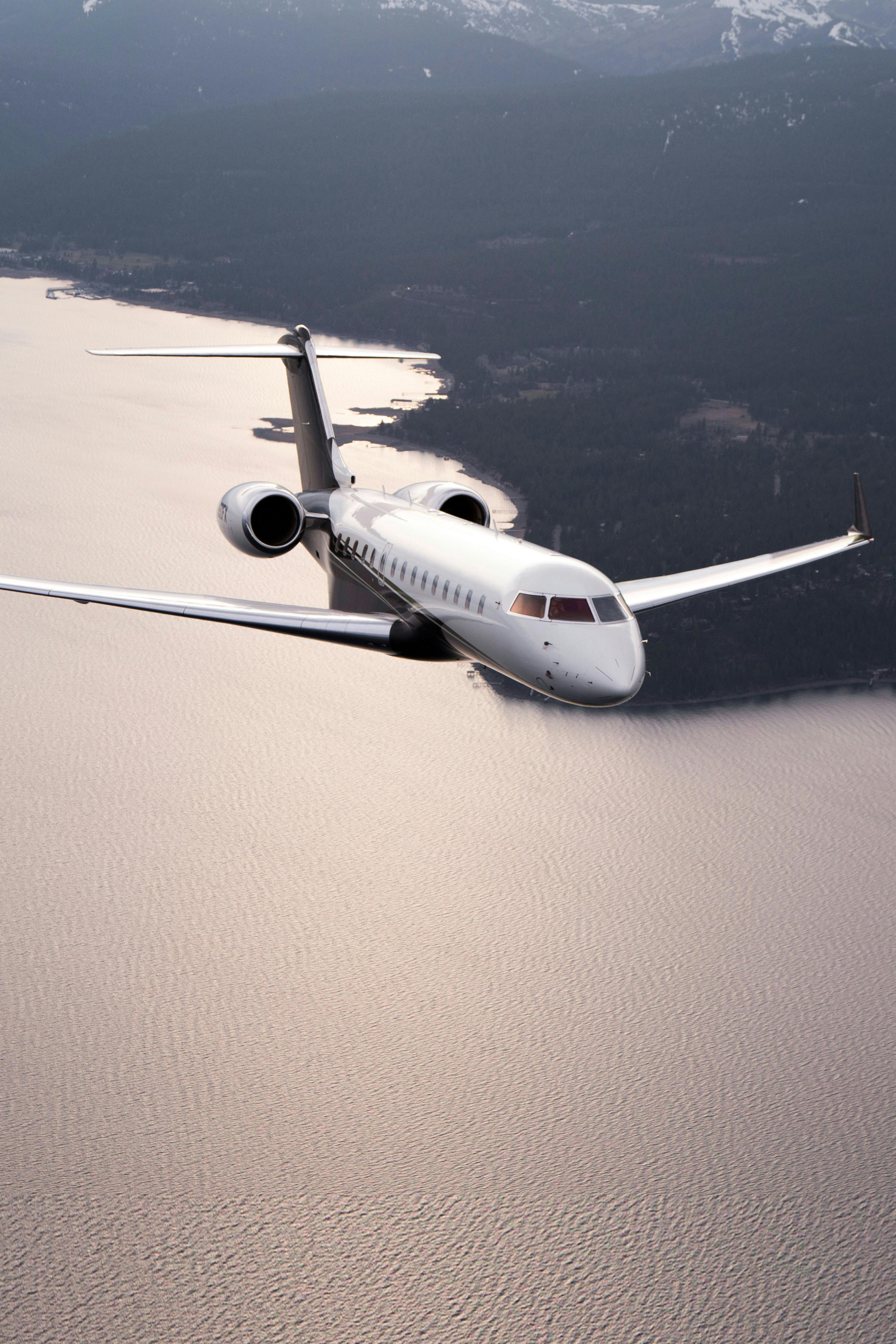 Global Express flying over land and water