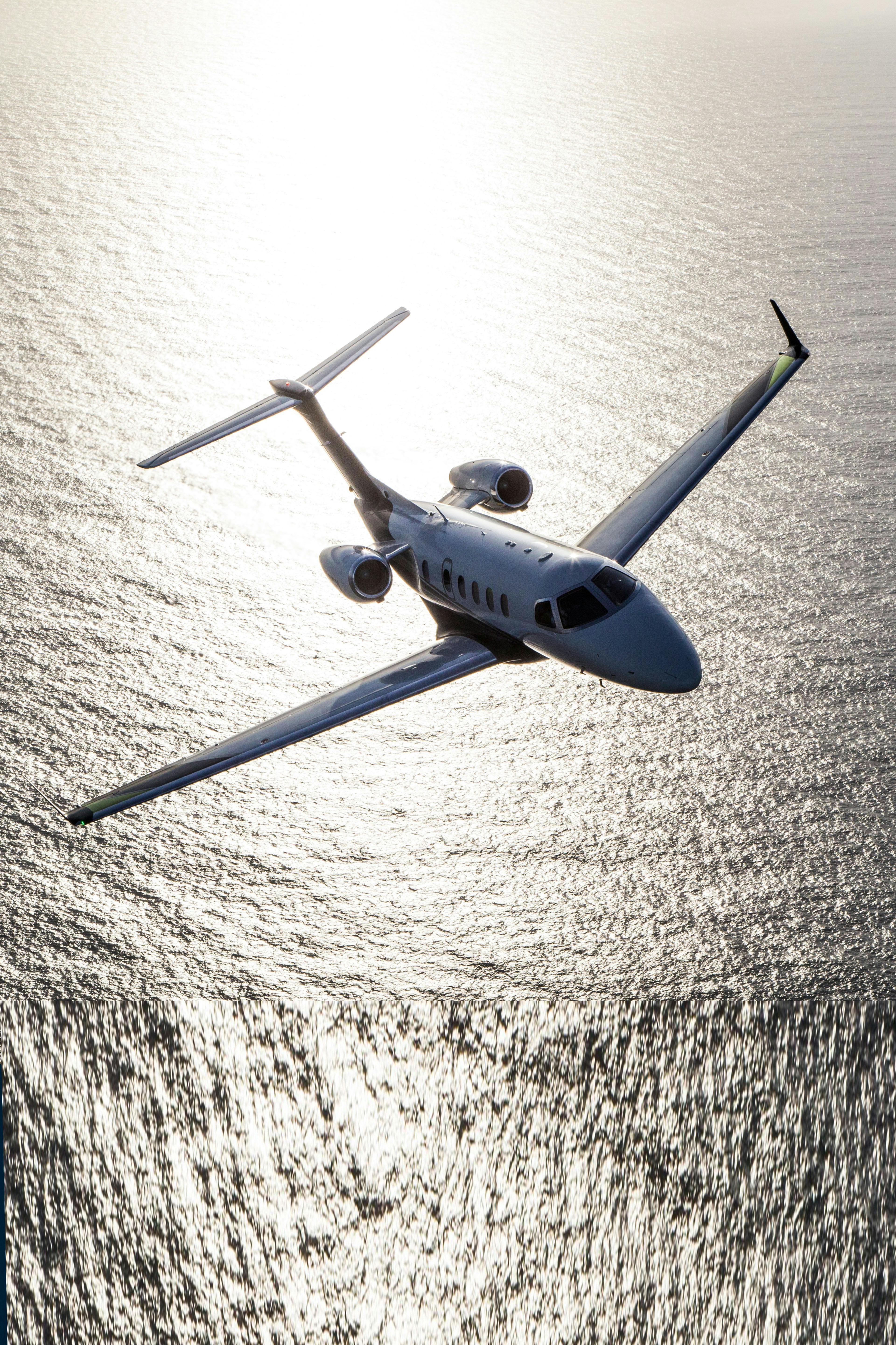 Phenom 300 flying over water