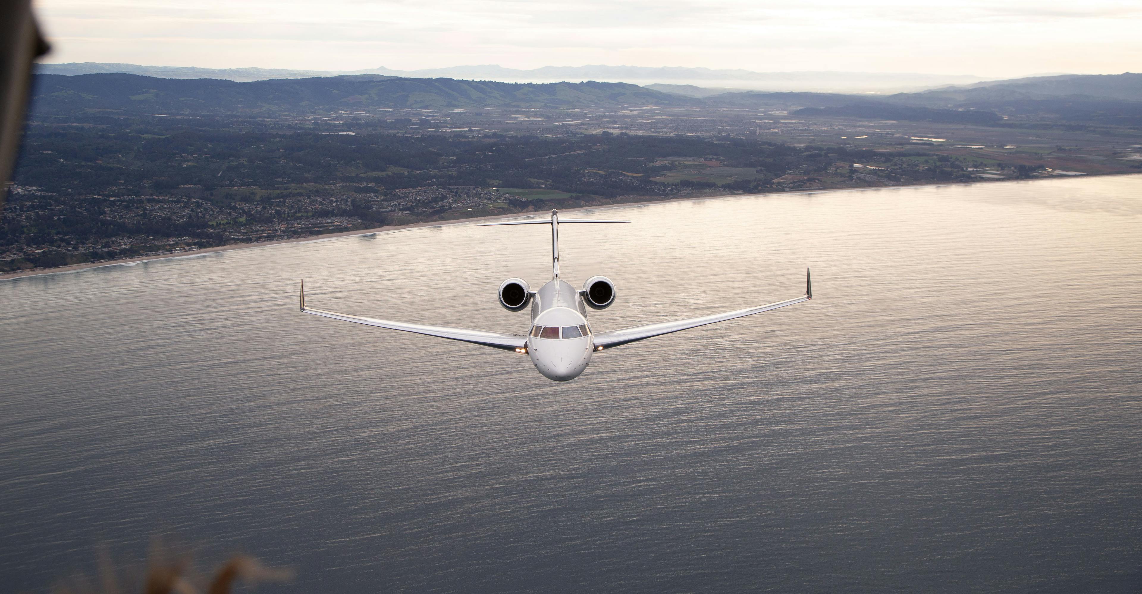 Image of aircraft flying over water, view from the front