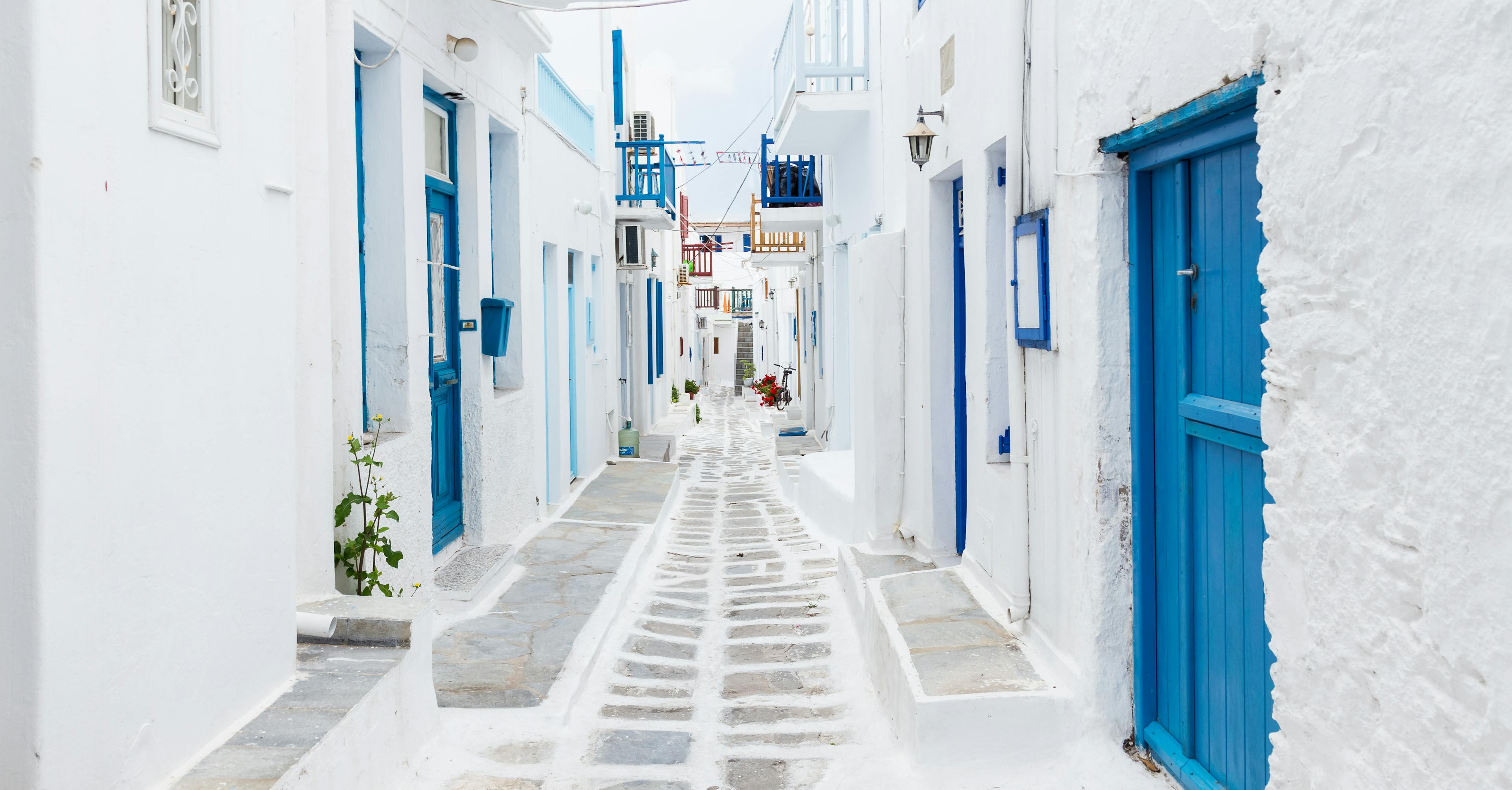 White and blue buildings line an ornate passageway